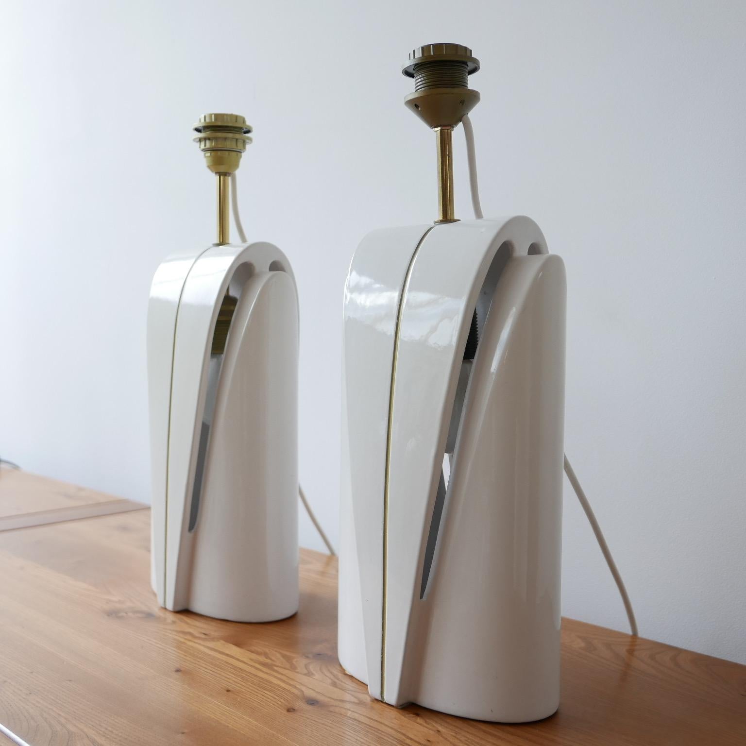 A smart pair of ceramic lamps. 

Late 20th century, circa 1980s, Belgium. 

A clever design has an integrated internal bulb in the lamps body which diffuses light as well as the normal bulb holder. 

Very good condition, since re-wired and PAT