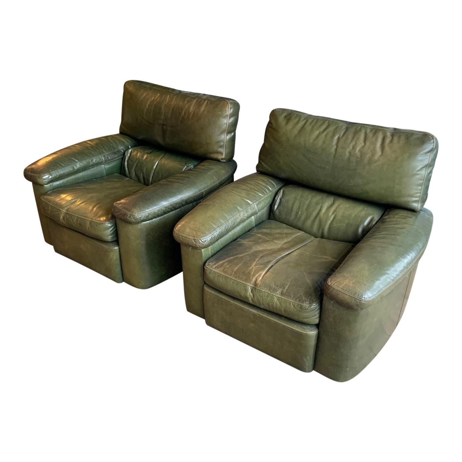 A pair of Green leather Armchairs circa 1970/1980, the chairs are extremely soft you literally sink once you're seated so perfect for wanting to settle down on a winters day.

The Green leather will make quite the impact in the right