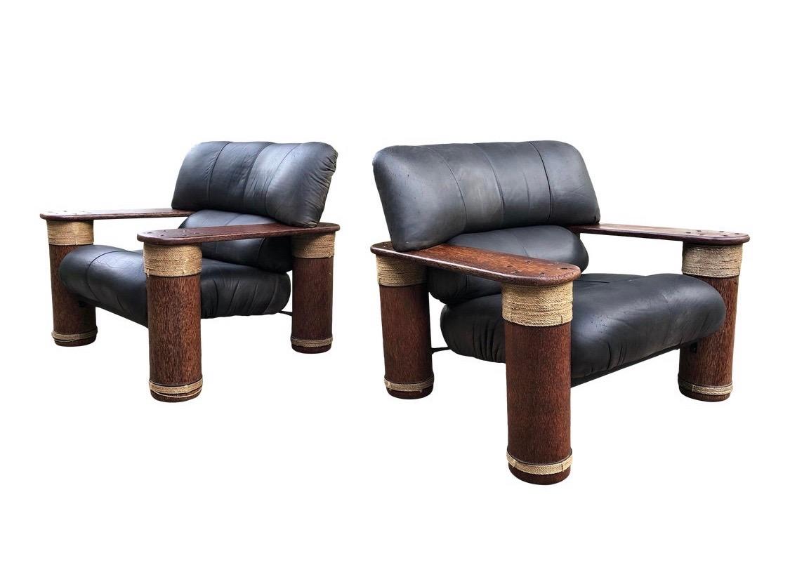 Featuring handcrafted palm wood arms and legs, this pair of rare pacific green Messina lounge chairs are a statement piece for your home. The patina on the leather shows well and the chairs are broken in perfectly. They are also structurally sound.