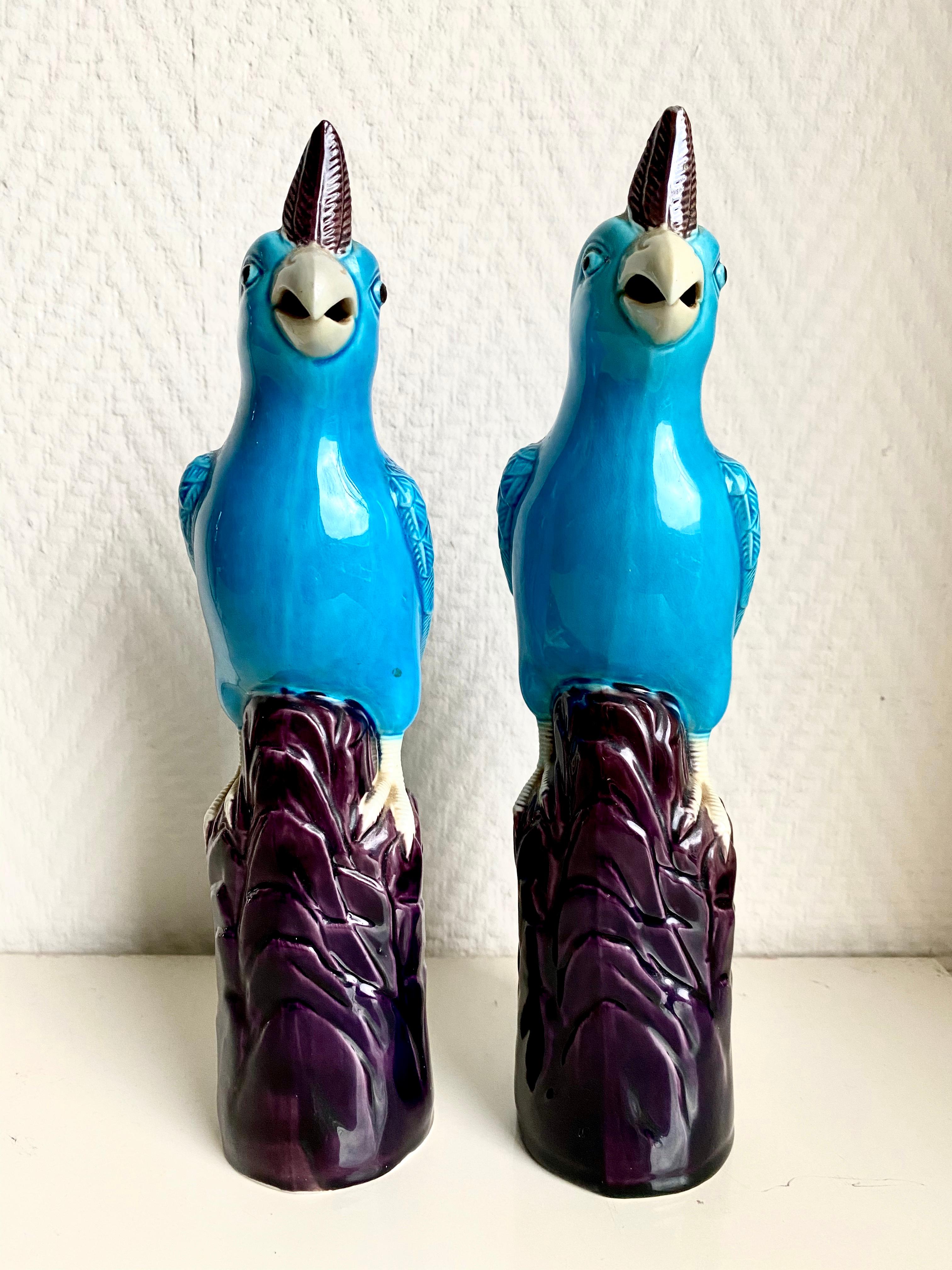 Wonderful pair of rare Chinese cockatoos which are resting on a deep purple log, feature beautiful Turquoise feathers and even small tongues. The two birds remain in very good condition with only minor wear. No chips or flee bites. 