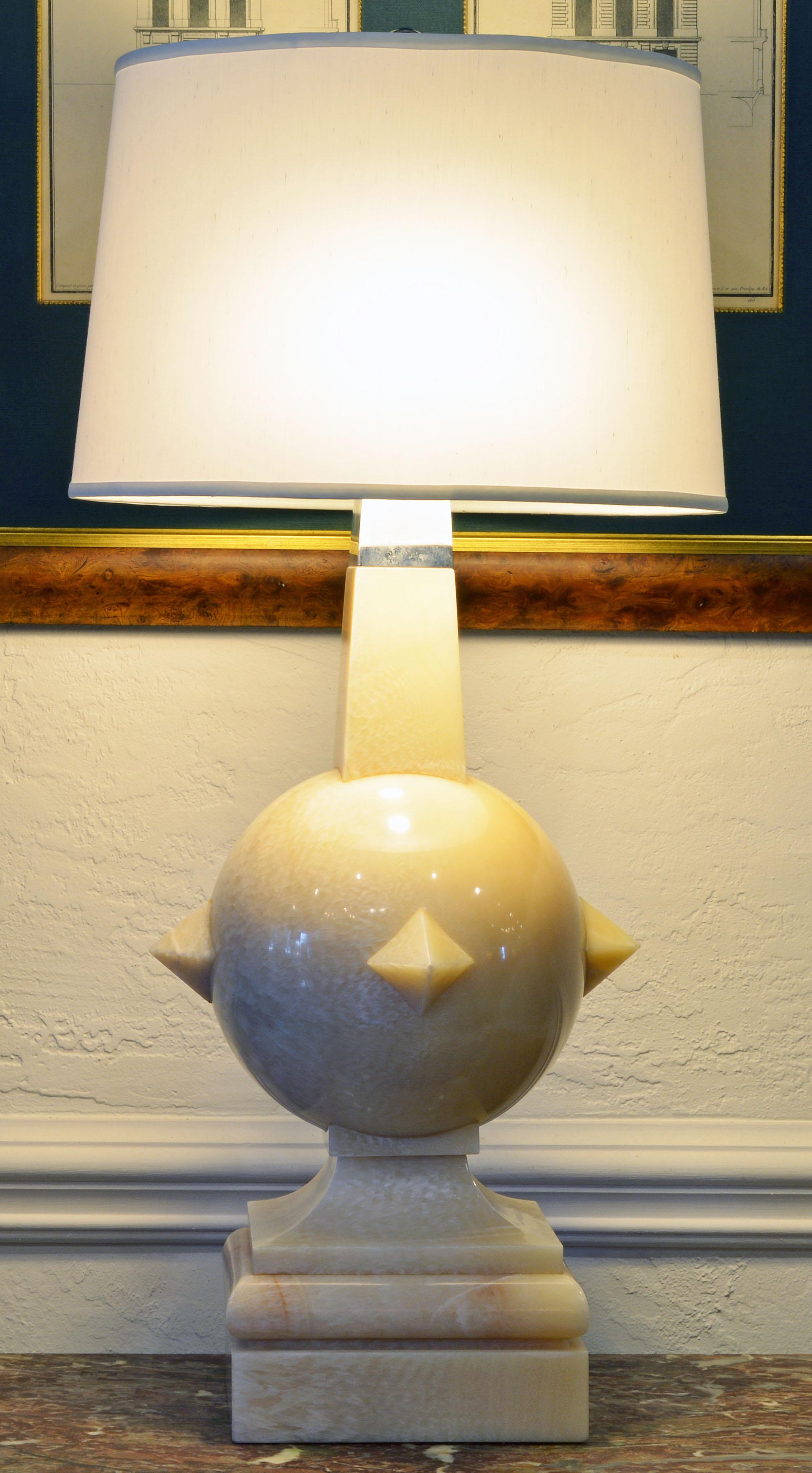 Likely of Mexican origin these impressive lamps combine a modern design with archetype elements, the sphere, the pyramids and the obelisk. Carved in a cream colored almost translucent marble and fitted with a chrome top they make a powerful artistic