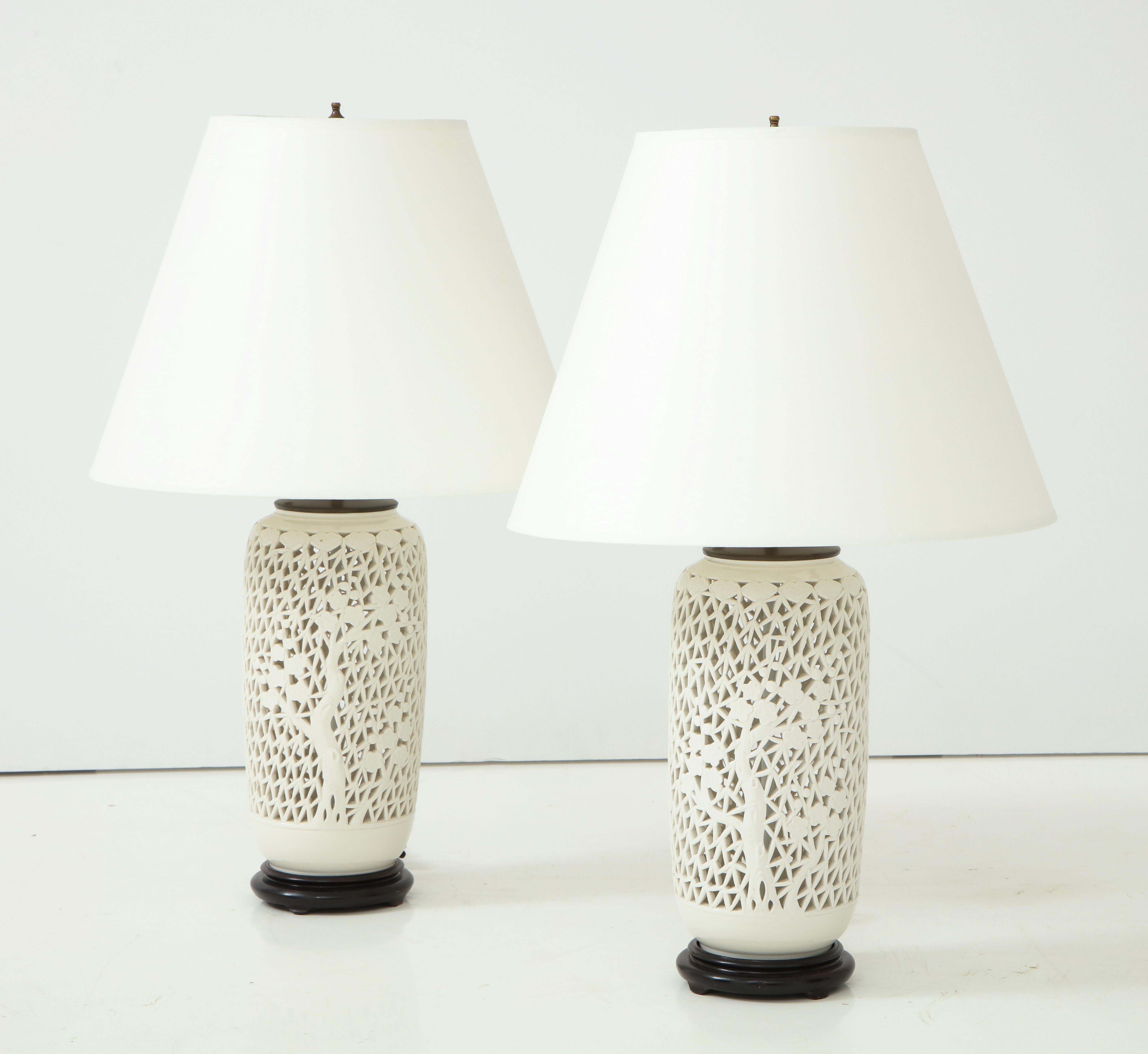 Pair of late 20th century reticulated white porcelain lamps on hardwood bases.
Chinese, circa 1960-1970.
