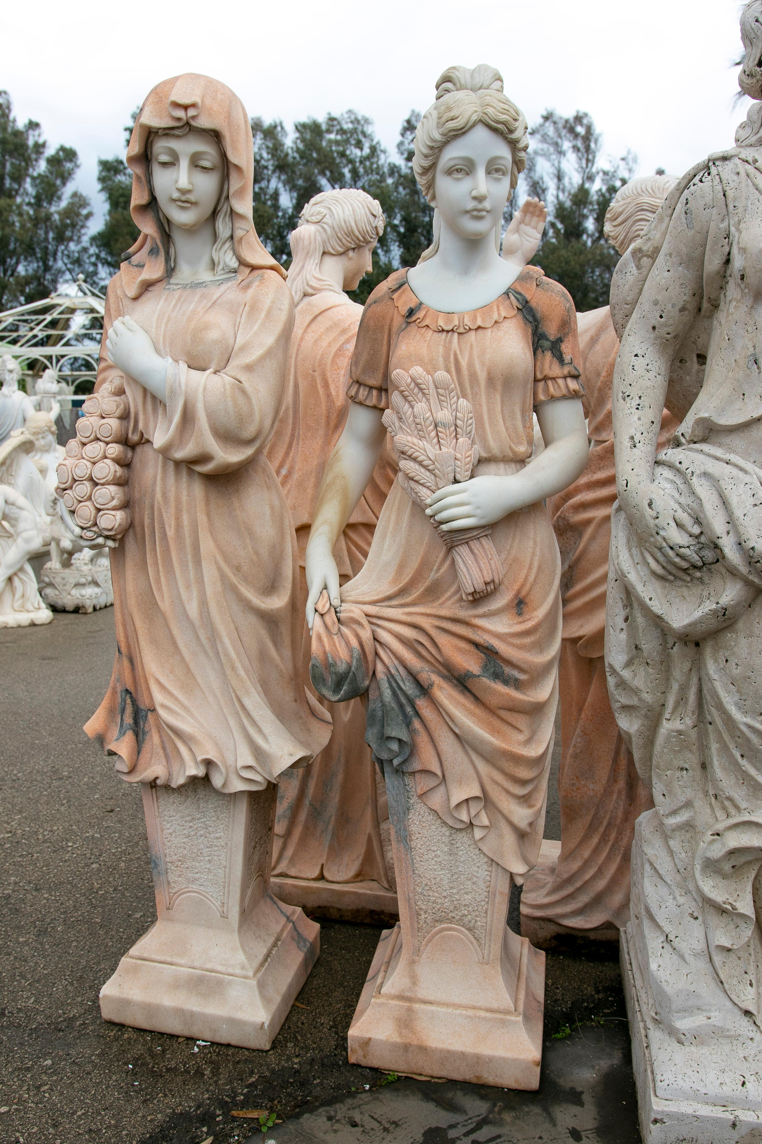 Pair of 1990s Spanish hand carved Carrara white and Portuguese Rosetta pink marble woman sculptures.