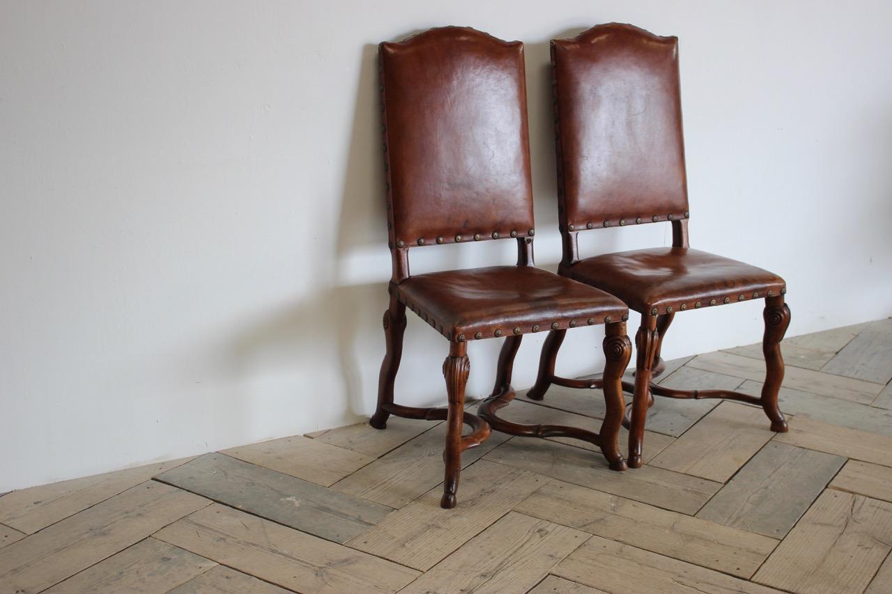 A good pair of 18th century Italian side chairs with studded leather and hoof feet, on a walnut frame,
circa 1800 Italy
Floor to seat: 47cm height.