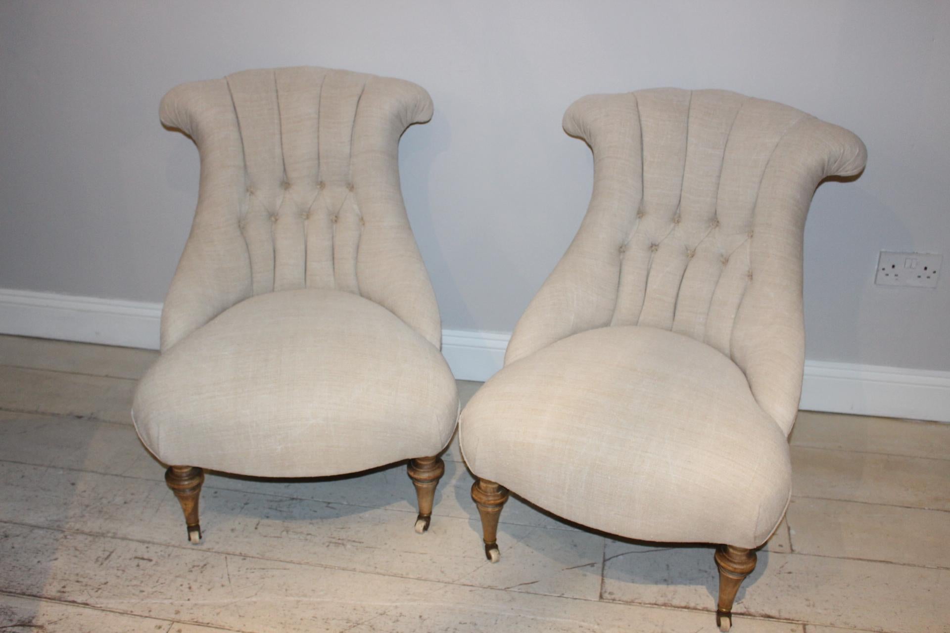 Pair of button-back upholstered late circa 19th century Swedish chairs. A pair lovely salon chairs sit on turned beech legs and have been reupholstered in a neutral French linen to the front and hessian to the back with feature flat piping. These