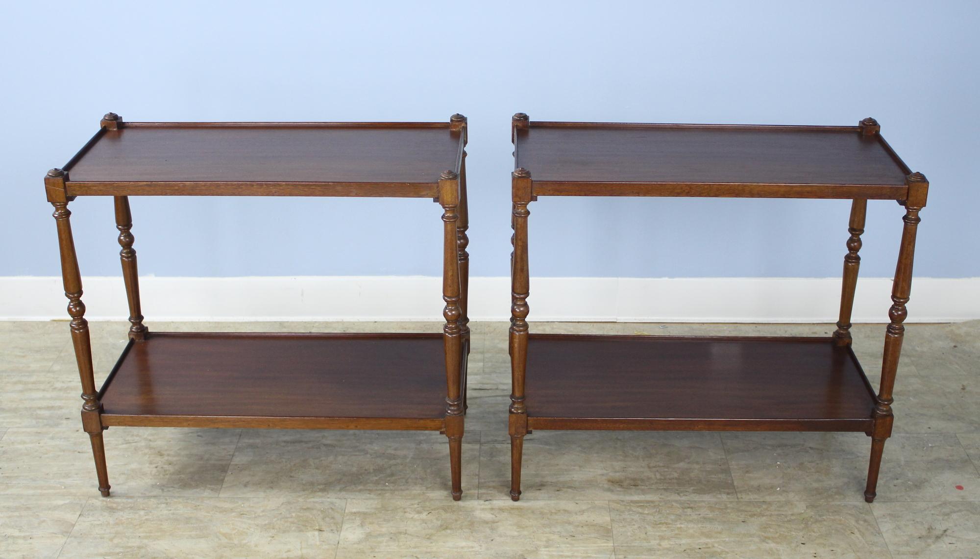 A pair of graceful matching Georgian end tables with slim turned legs. There are 16 inches between the top and bottom shelves. These would also make good nightstands.