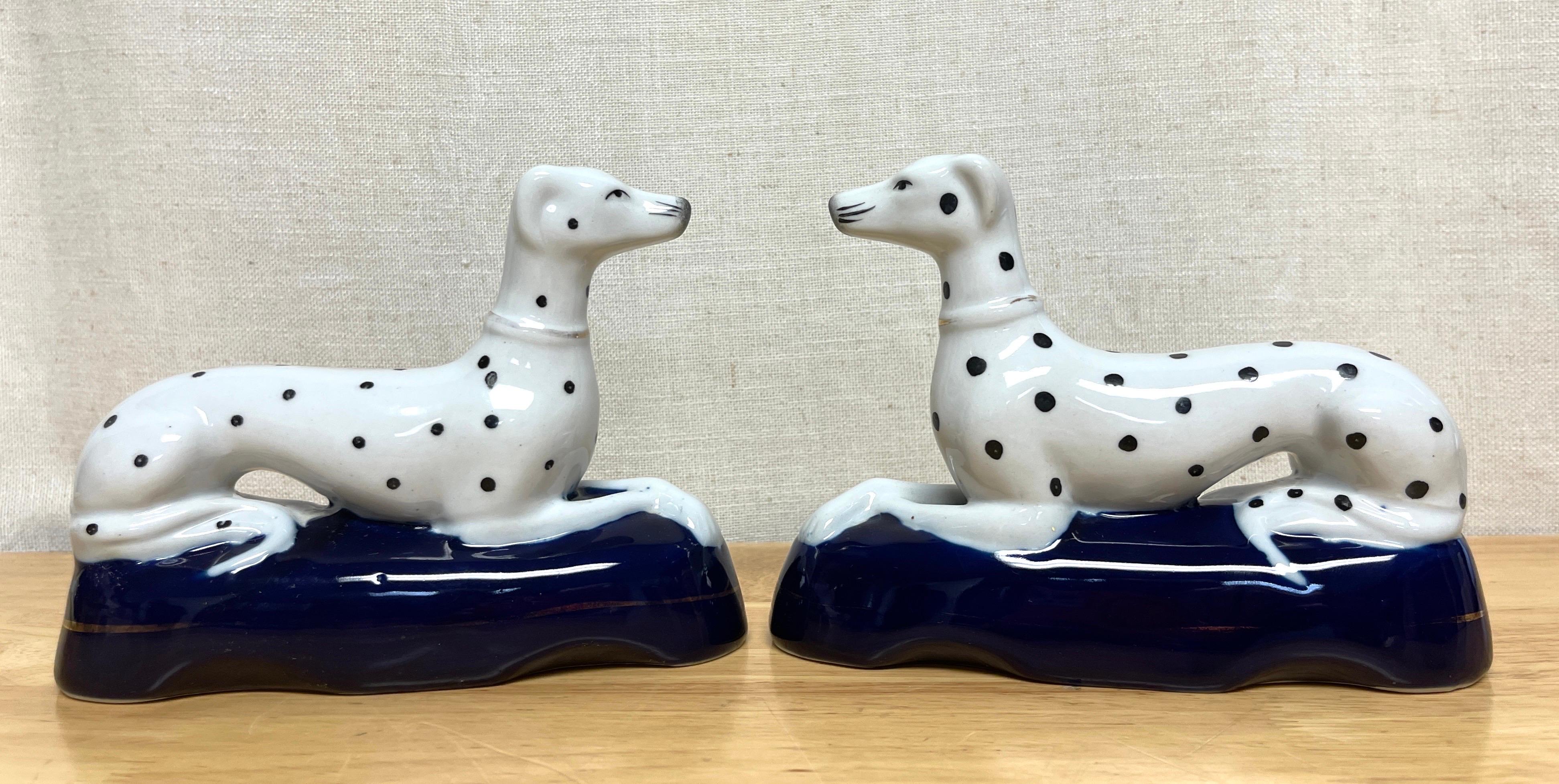 Pair of late Staffordshire Recumbent figures Dalmatians 
USA, 20th 1950s

A good pair of a later Staffordshire hand painted and enameled porcelain figures of reclining Dalmatians. Each one an elongated seated Dalmatian realistically modeled, with