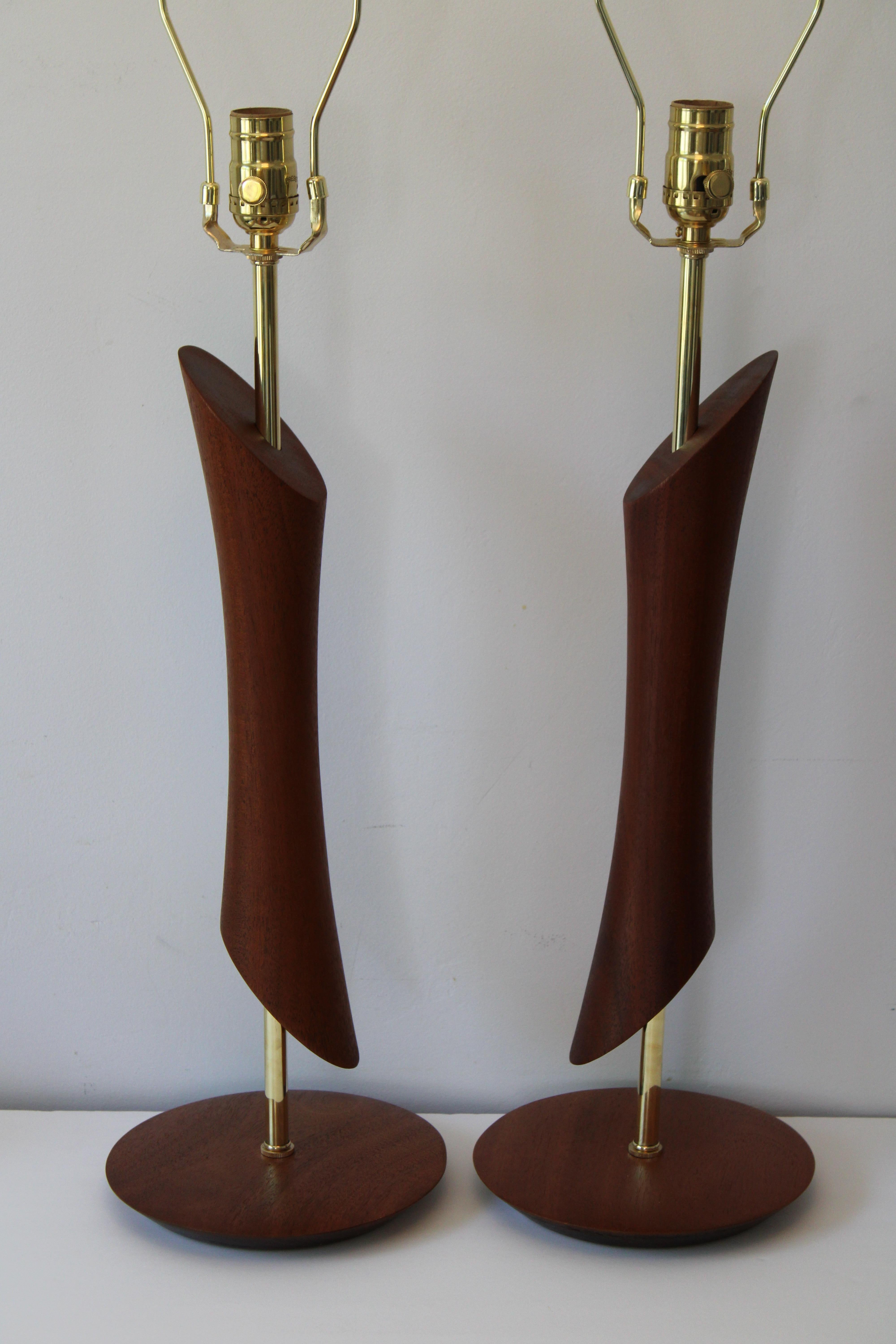 Pair of mid century lathe cut walnut lamps. Each lamp measures 21