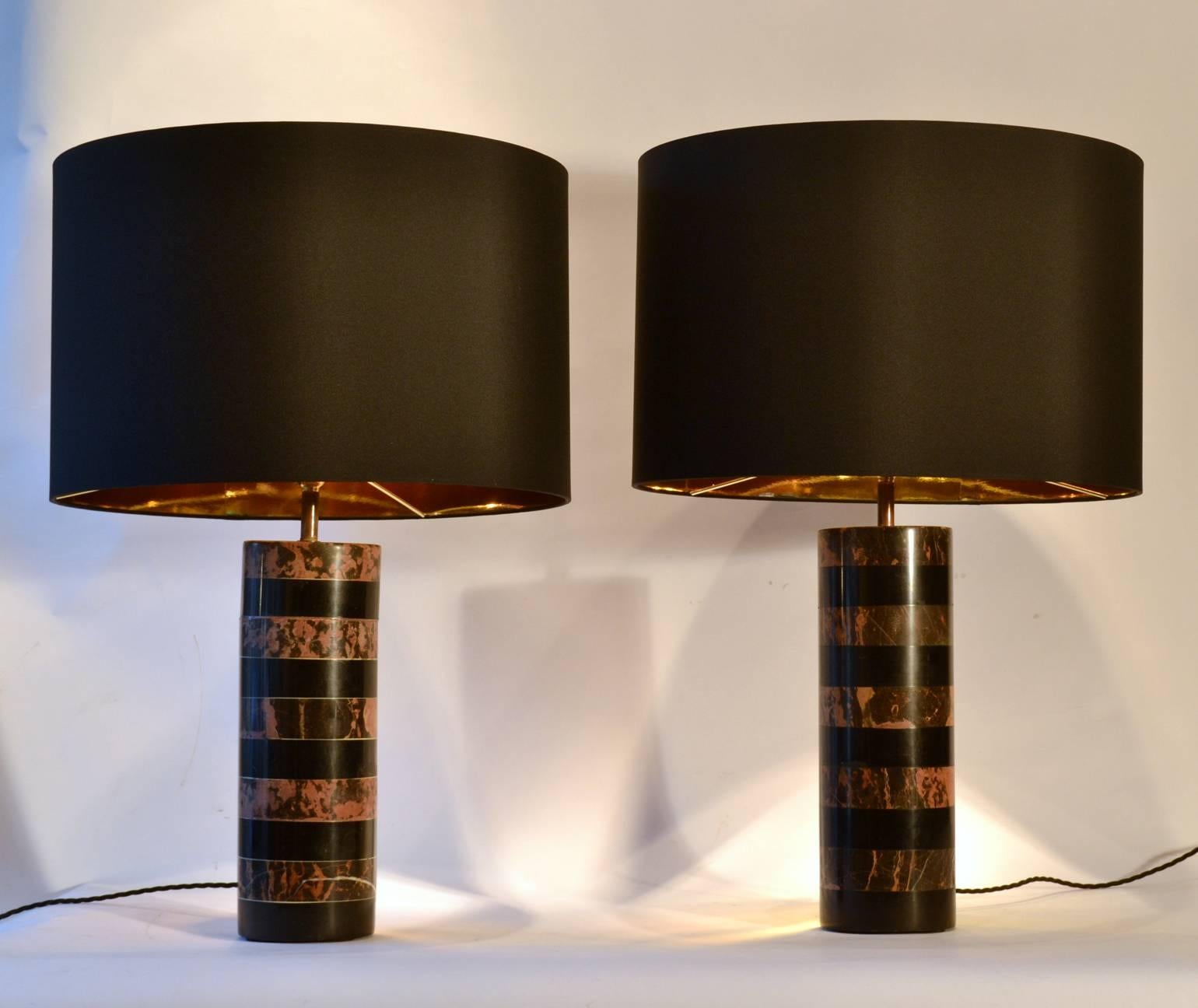 Layers of black marble with alternating black & pink layers of solid marble make this pair of 1970's cylinder table lamps elegant and classic.
The black & gold drum shape shades, D45cm. are new.