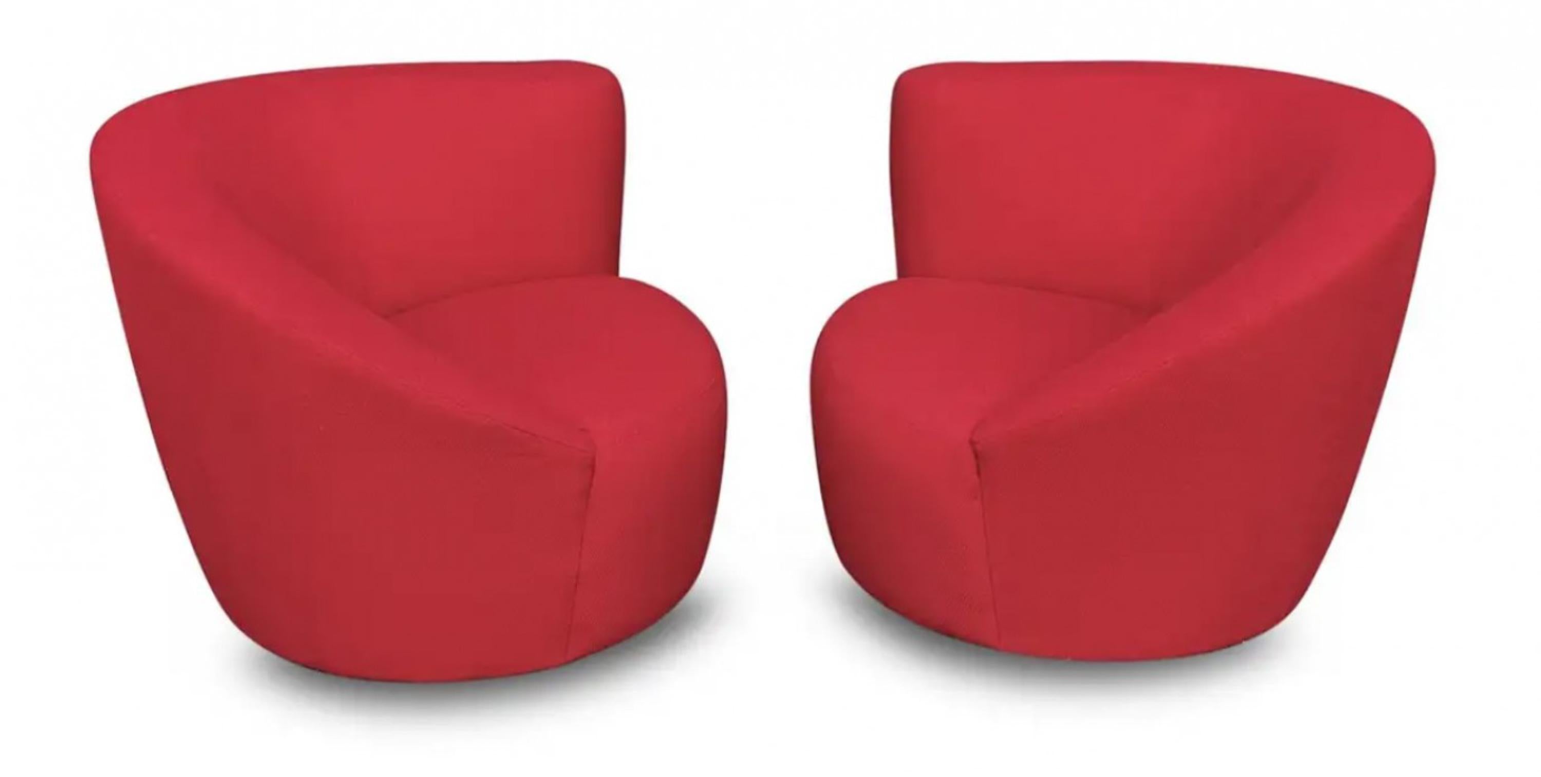 A pair of Lazar manufactured swivel lounge chairs, showcasing a dramatic flowing curved arm rest. The chairs features a return swivel mechanism, and the ottoman has castors.

These highly stylish loungers are as comfortable as they are attractive.