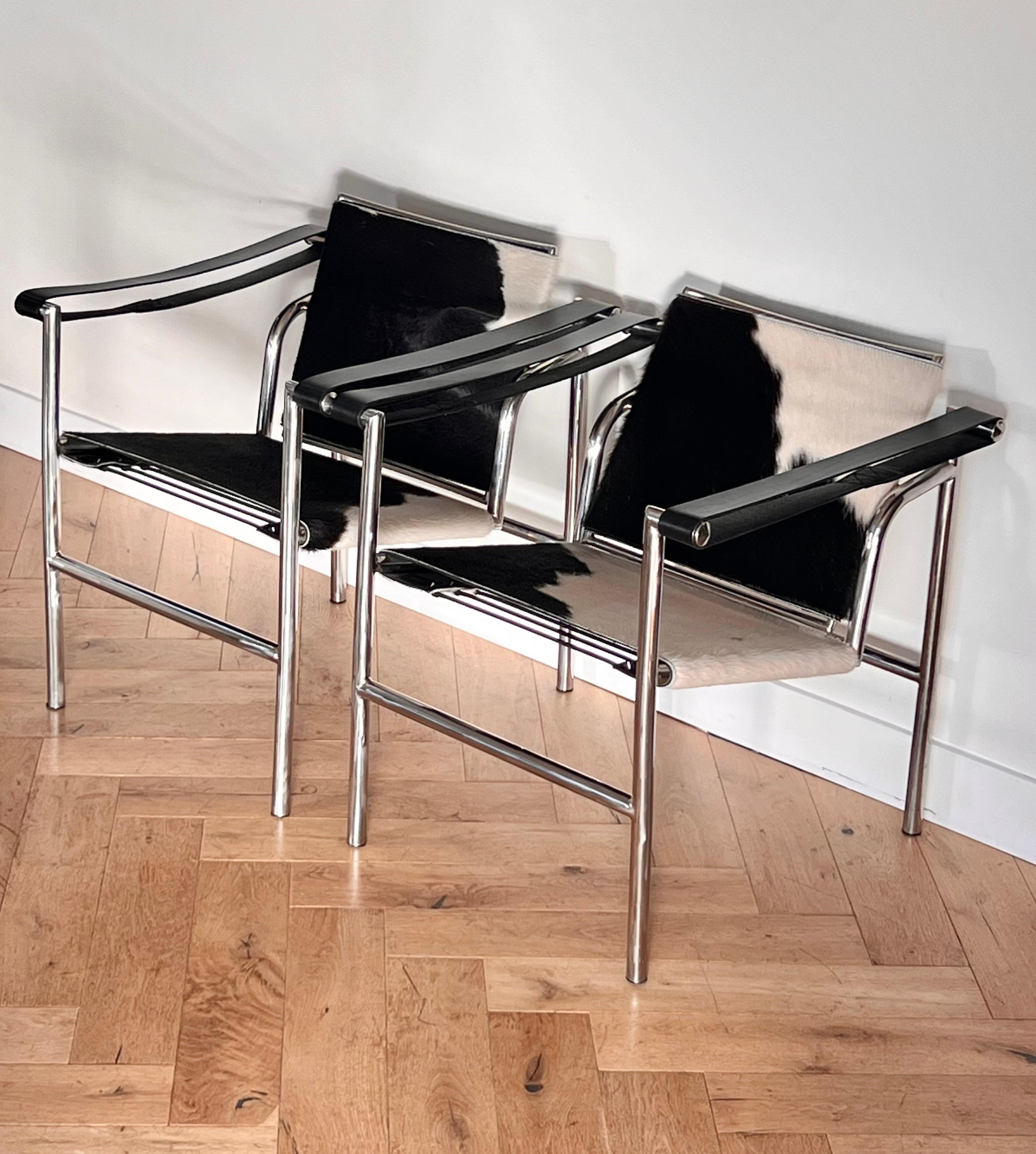 A pair of Lc1 cowhide basculent chairs by Perriand, Jeannette, and Le Corbusier, France/Italy 20th century. Chrome-plated steel and leather. Circa 1980 Cassina reproductions of the Bauhaus 1929 originals. Signs of age are slight but include minor