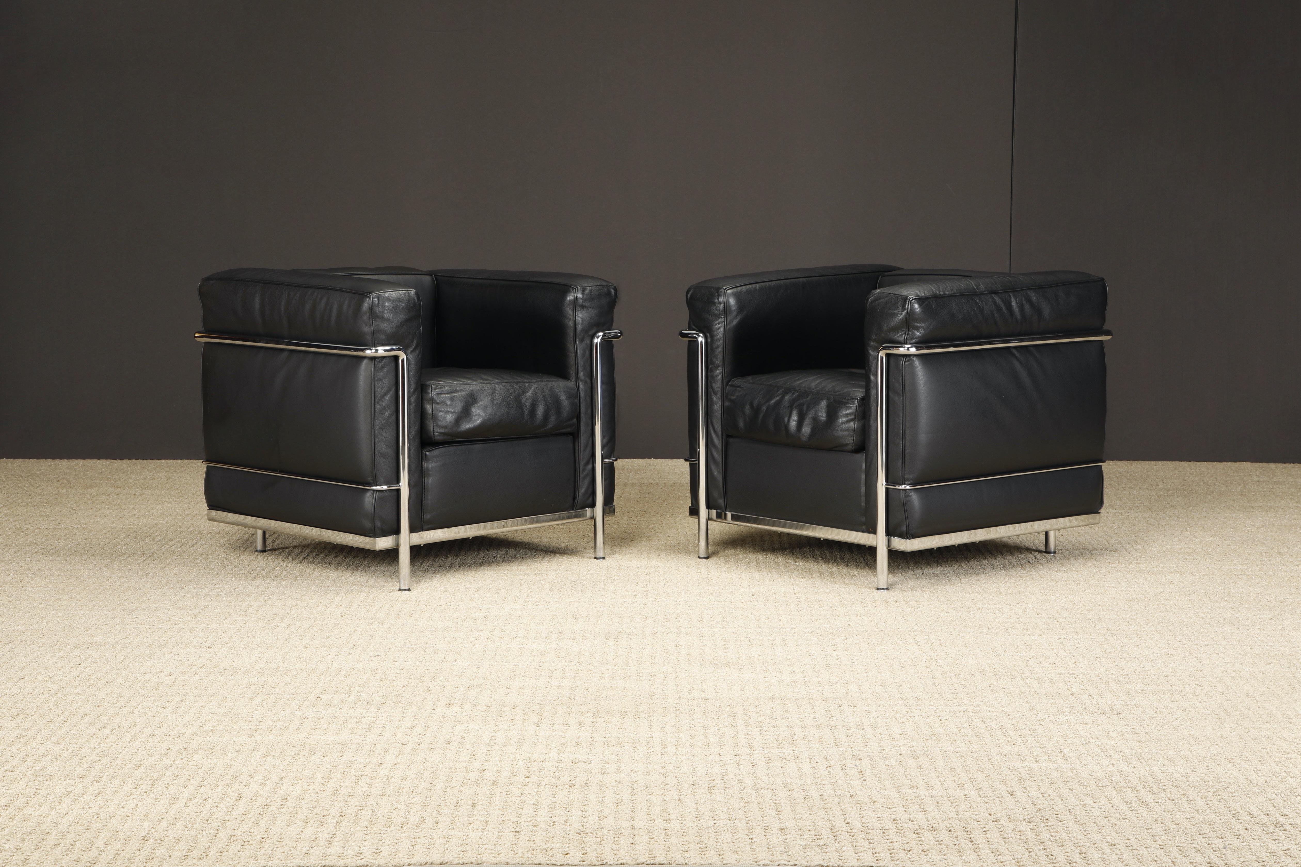 An incredibly comfortable pair of Le Corbusier for Cassina 'LC2' club chairs (authentic signed examples) in gorgeous thick Italian black leather.

The LC2 was designed in 1928 by Le Corbusier; his cousin and colleague Pierre Jeanneret; and