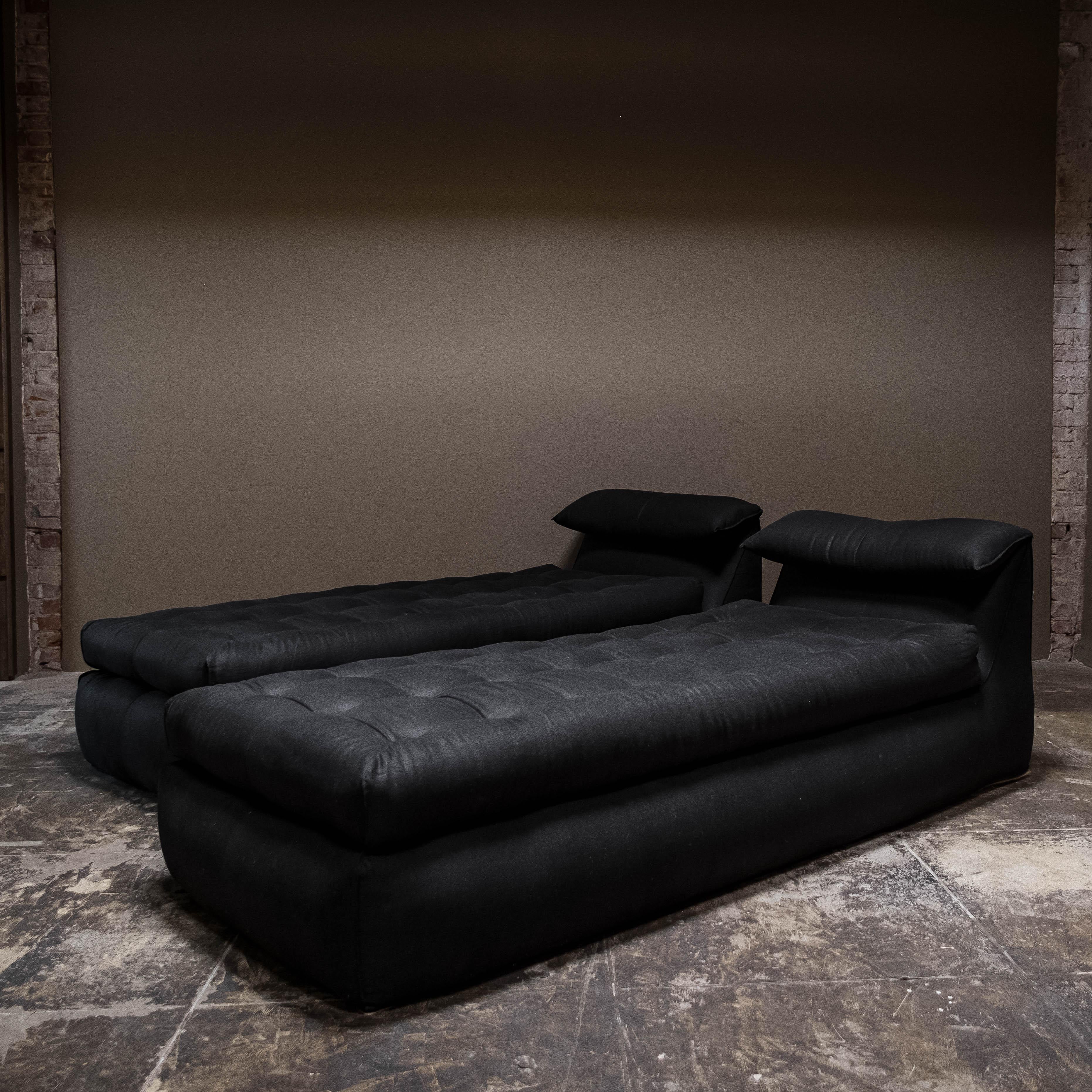 Ti presentiamo una splendida coppia di lettini da giorno Le Bambole, realizzati magistralmente da Mario Bellini per B&B Italia nel 1970. Questi pezzi pregiati sono stati rinnovati con un elegante rivestimento in lino nero con le etichette originali