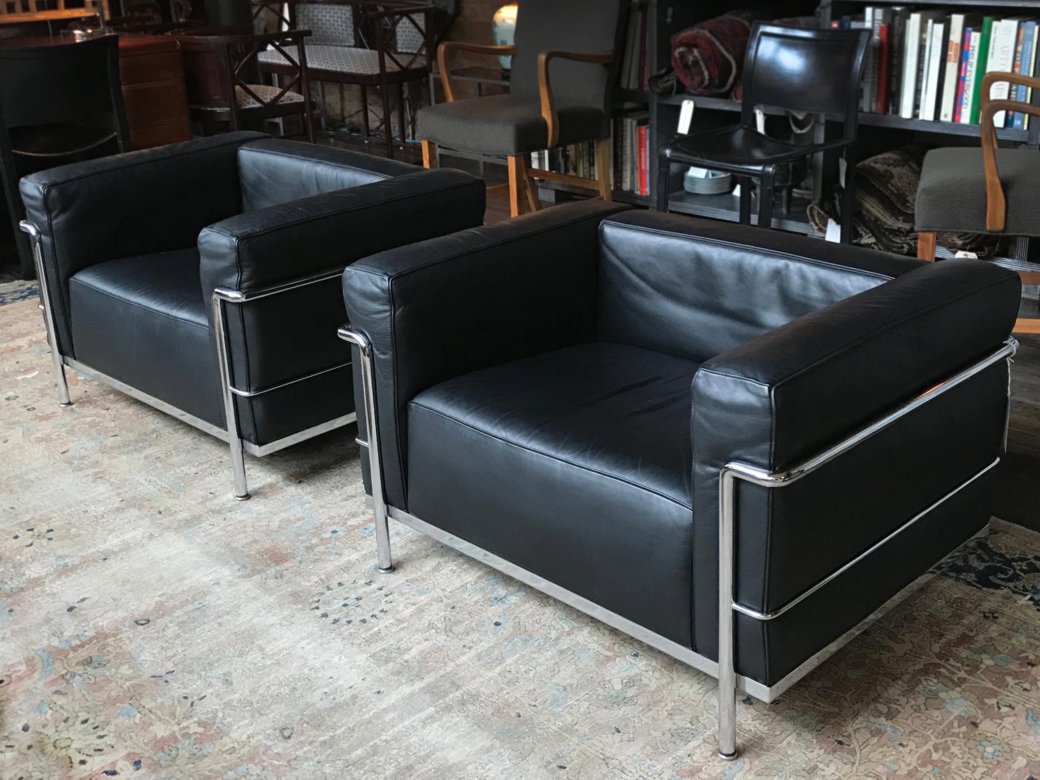 A pair of the iconic Bauhaus LC3 club chairs. Conceived by Le Corbusier, Pierre Jeanneret, and Charlotte Perriand and produced by Cassina, they are minimalist versions of traditional sofas and club chairs. The frame is chromed steel and is visibly