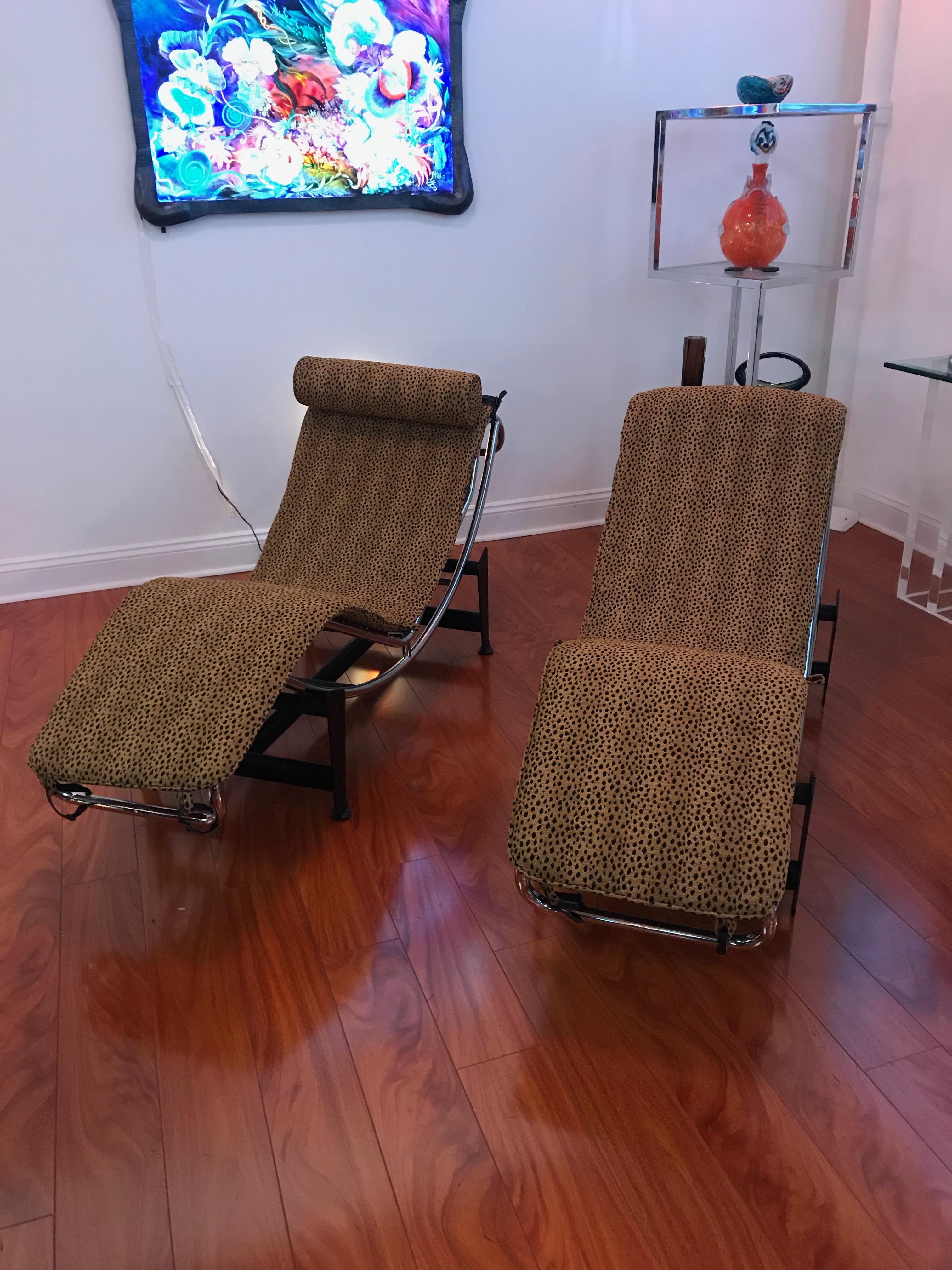 Mid-Century Modern pair of Le Corbusier LC4 style Leopard print and chrome lounge chairs. One of the lounge chairs has a matching leopard pillow. The cushions have been reupholstered in faux leopard print.