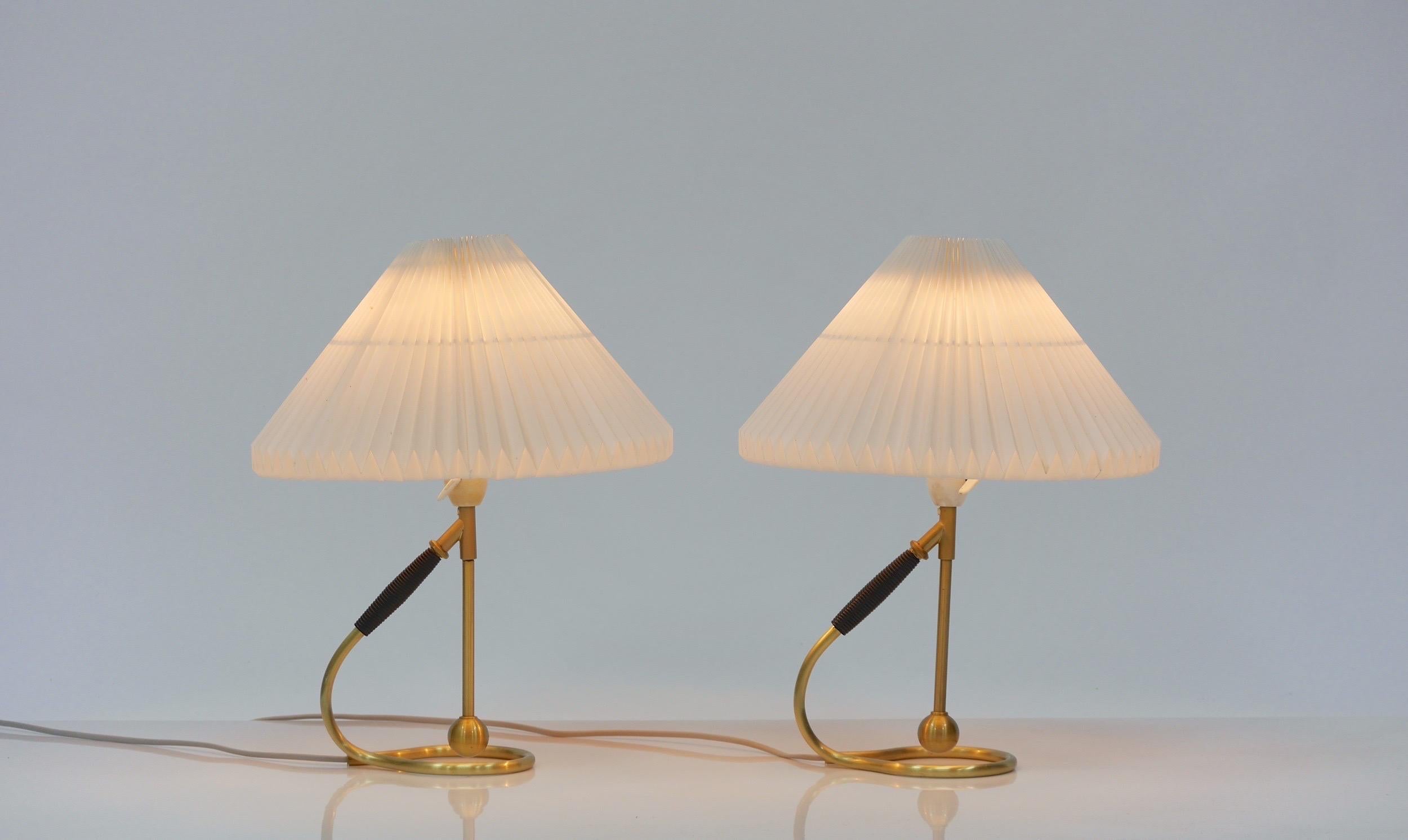 Pair of vintage Le Klint 306 table/ wall lamps( Kip-lampen in Danish ) This versatile lamp was designed by Kaare Klint in 1945. With it’s tilt function the design easily converts from a table lamp to wall sconce and vice versa. This adjustable