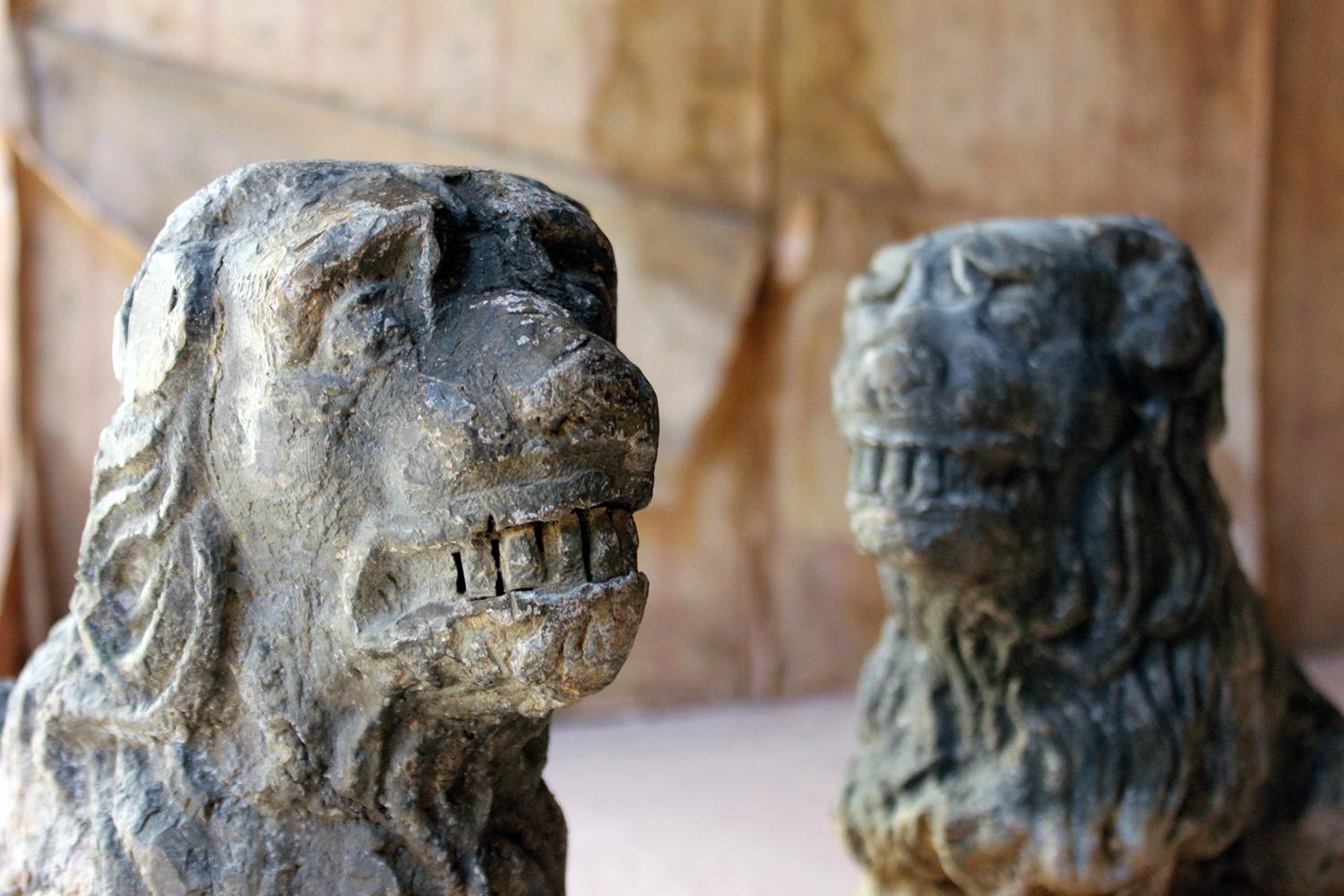 The solid lead sculpted figures of a pair of stylised lion-dogs, freestanding and formerly being the supports for a cistern, each showing a very good patination to the lead, and surviving from the latter stages of the 19th century.

The figures