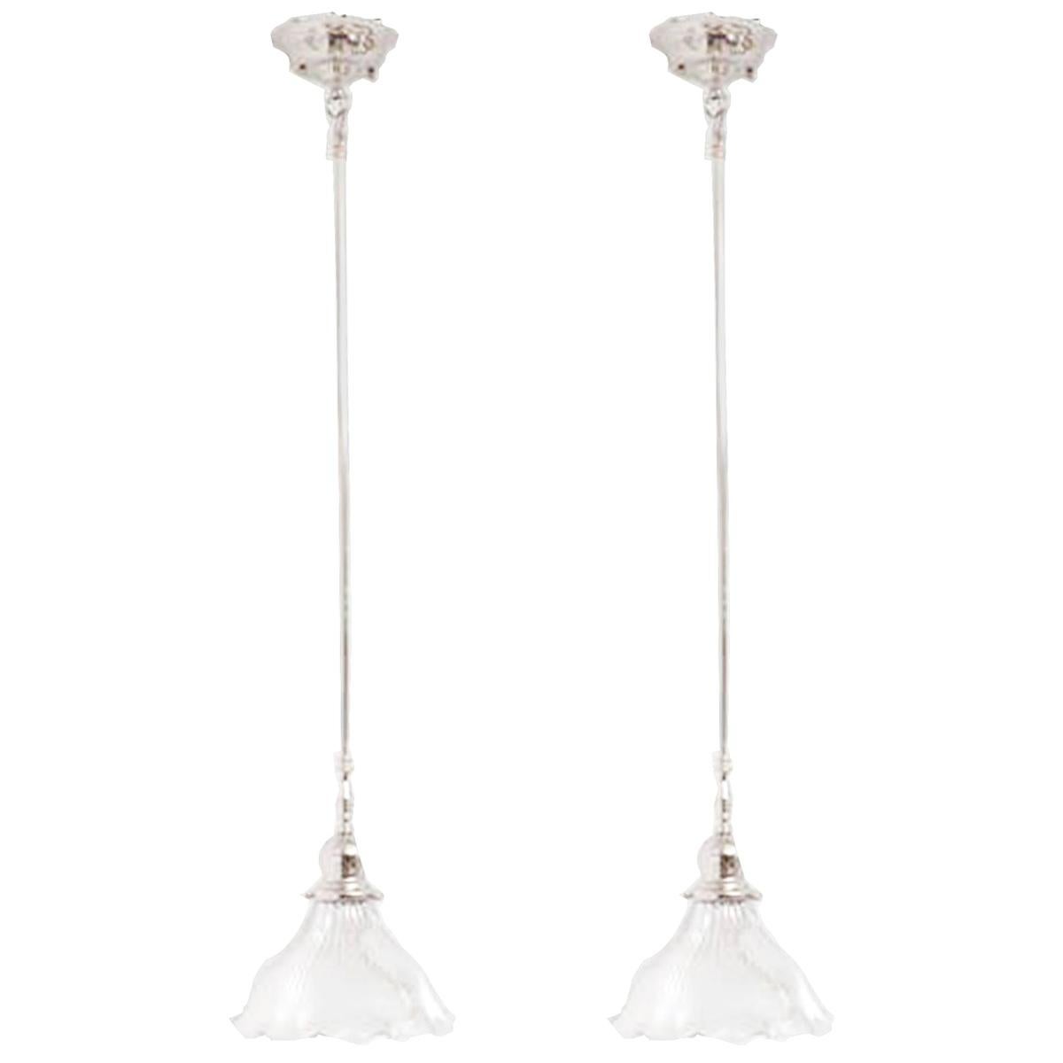 A rare lead crystal Holophane shade with a slight ruffle edge mounted on newer slender reeded, nickel plated pendant. Stem can be shortened if need be. Takes a regular size light bulb. American.
