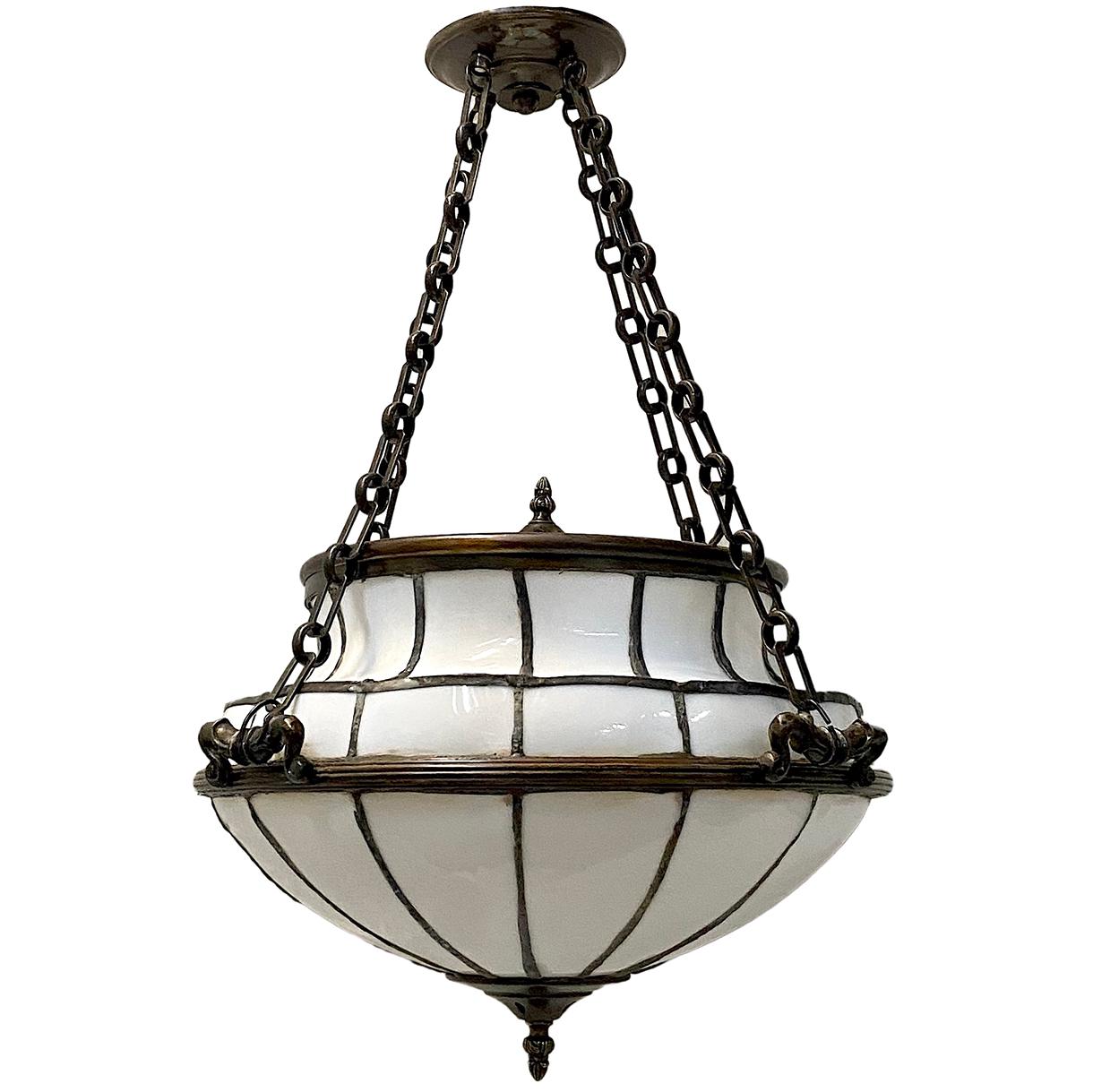 Pair of English, 1920s light fixtures with 6 interior lights. The body of the fixtures with three handles that hold three chains. 
Measurements:
19