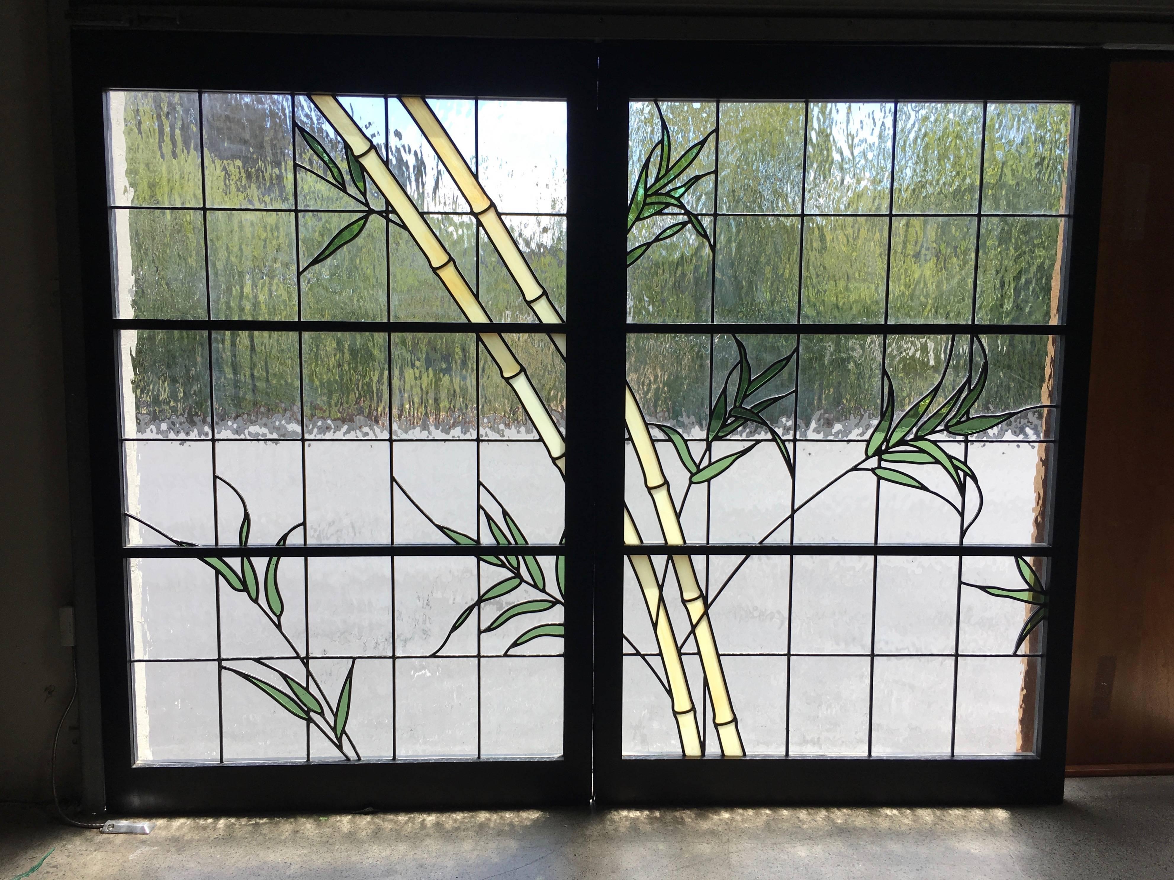 Pair of stained glass windows in a bamboo motif each one measures 36.25 wide.