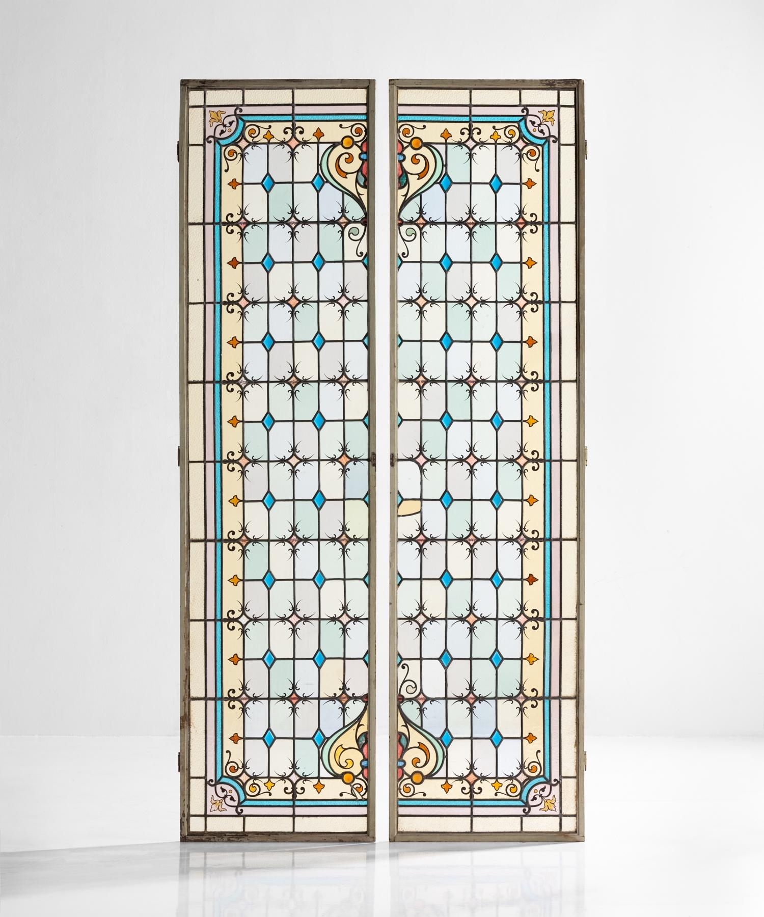 Pair of leaded and painted glass shutters, France, circa 1890.

Detailed geometric patterning on glass panes with iron supports in original wooden shutters.