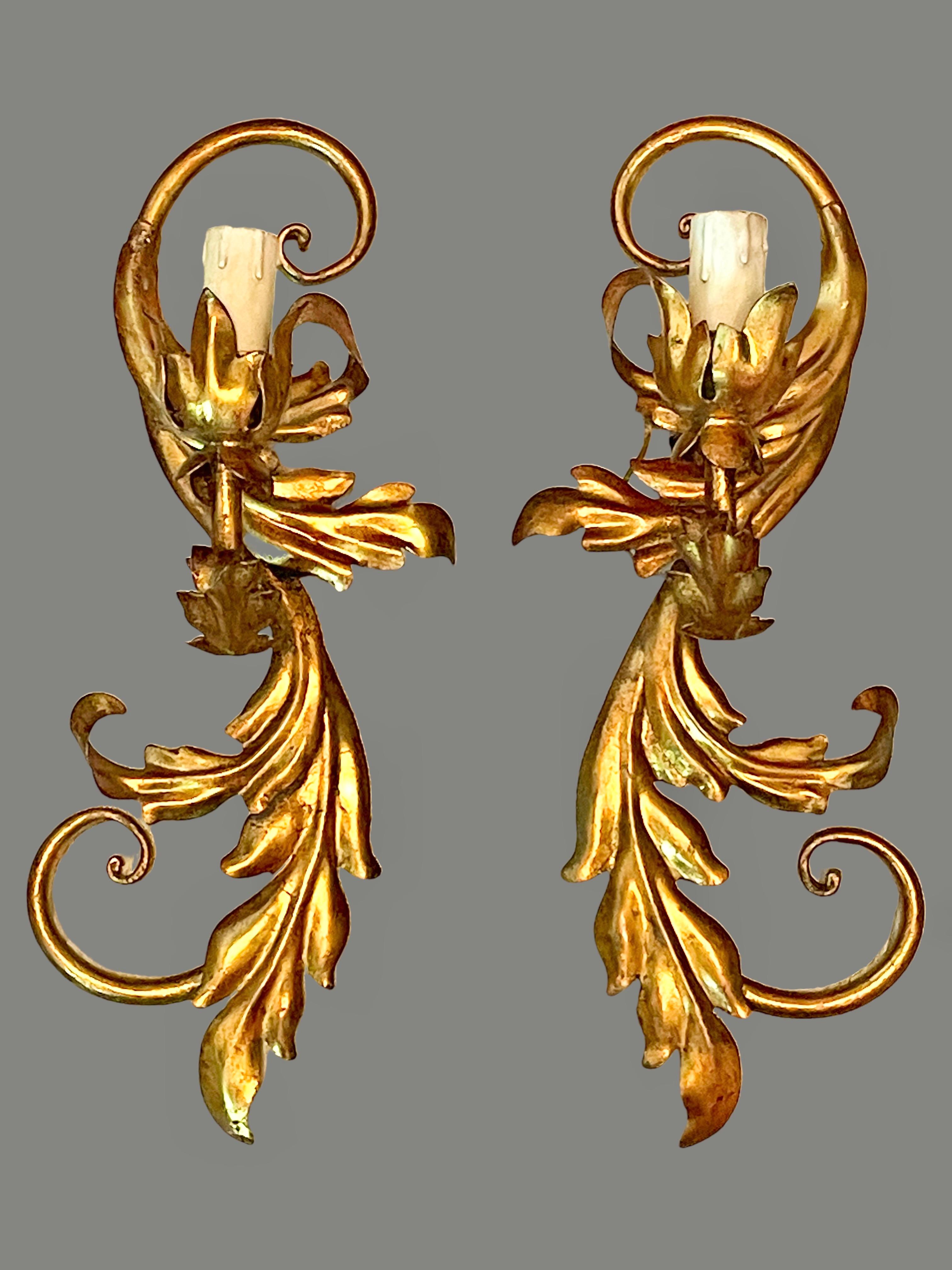 A pair Hollywood Regency midcentury gilt leaf tole sconces, each fixture requires a European E14 candelabra bulb, up to 40 watts. The wall lights have a beautiful patina and give each room a eclectic statement. Made by Koegel Kogl Leuchten Germany.
