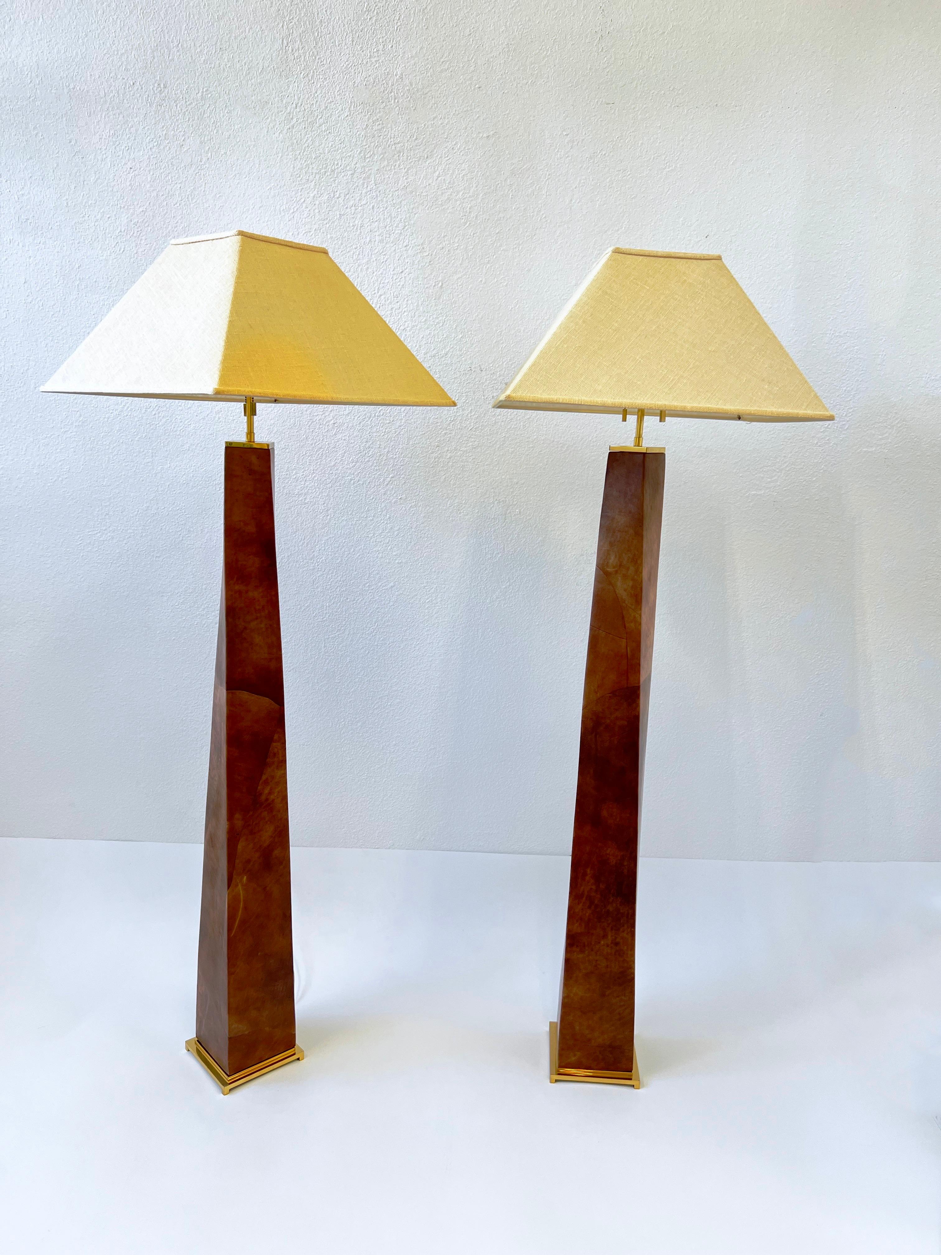 A spectacular pair of 1980’s polish brass and leather J.M.F. floor lamps by renowned American designer Karl Springer. The lamps are constructed of solid brass and wood that’s covered In a patchwork saddle tan leather. The shades are burlap.

Newly