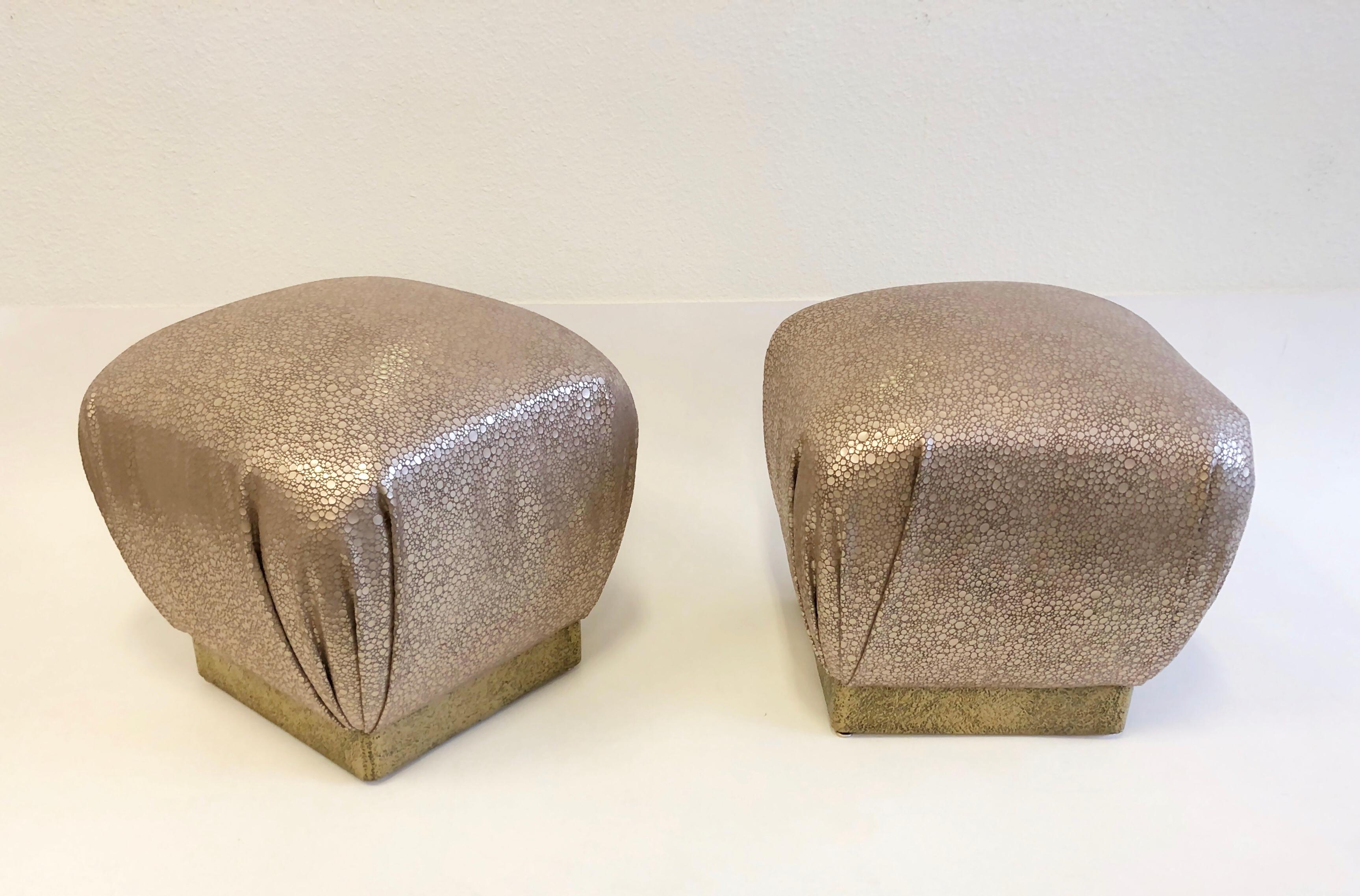 A pair of custom leather poufs with a Brutalist brass base design by Marge Carson in the 1970s. The poufs have been newly recovered with a soft lite rose champagne color leather (see detail photos).
Dimensions: 18.5” high, 19” wide, 19” deep.