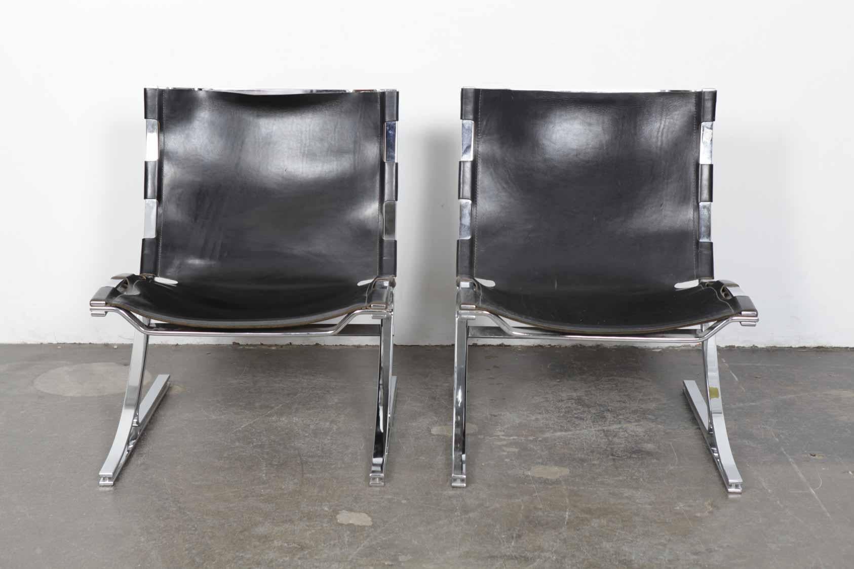 Pair of very rare flat bar metal and original black leather sling chairs designed by Meinhard Von Gerkan, German Architect, in 1972 for the VIP lounge in the Berlin Airport. A total of 48 of these were produced by Walter Knoll. These are from the