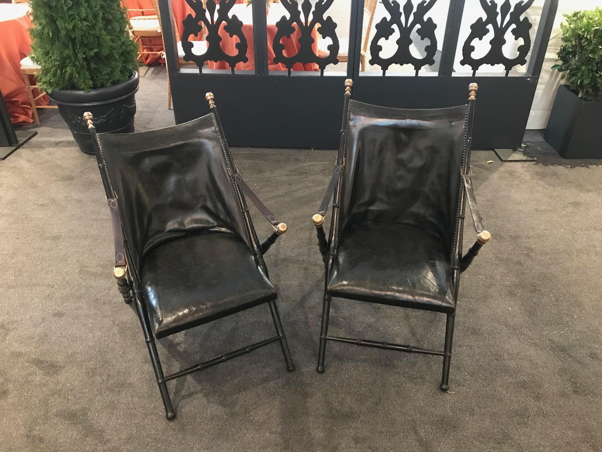 Pair of leather and ebonized pear wood folding chairs by Maison Jansen. 


 
             
