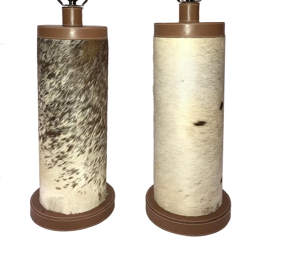 A pair of circa 1950's French hide-covered table lamps, with leather stitched base and top.

Measurements:
Height of body: 18