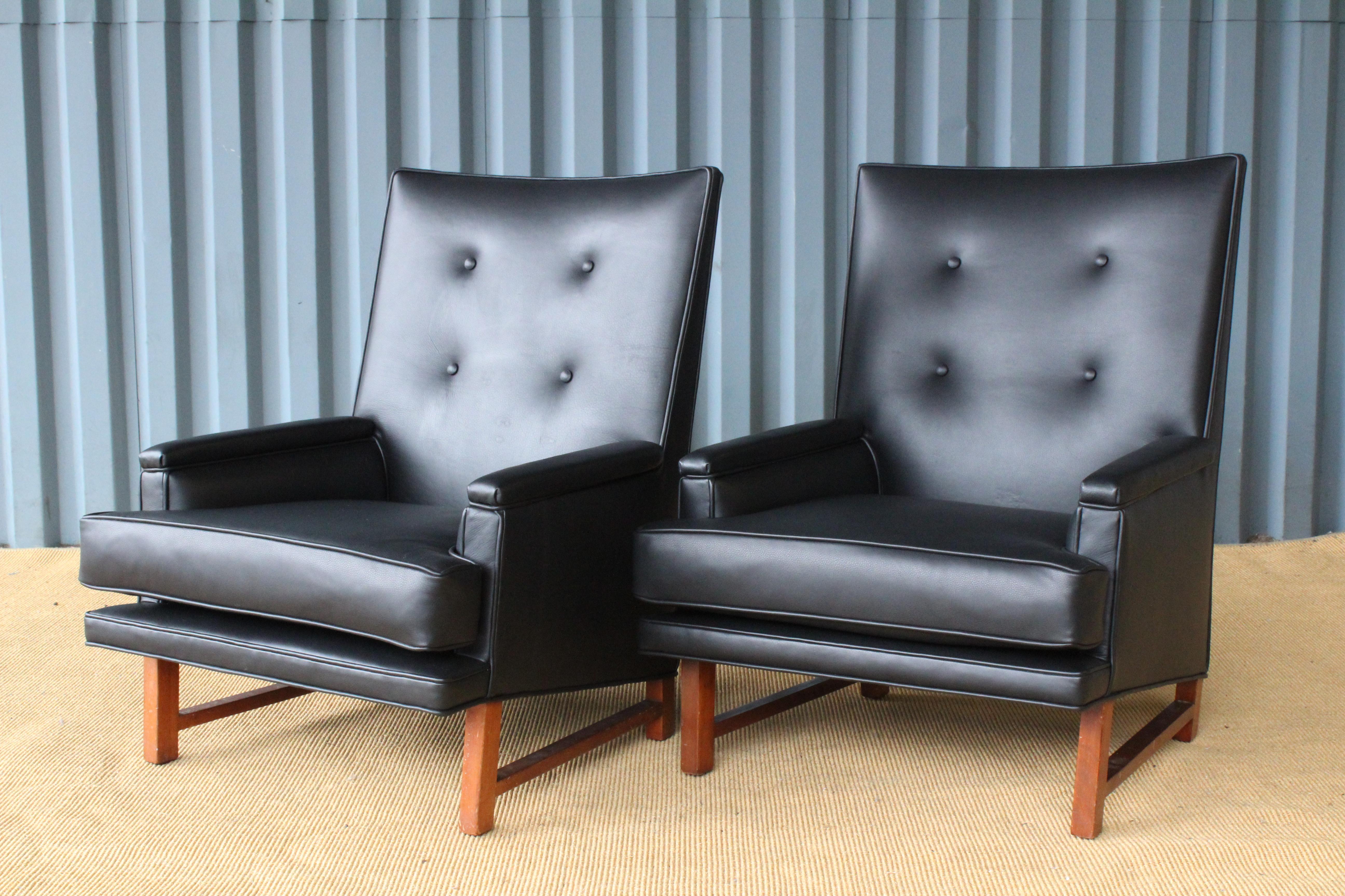 Pair of high back lounge chairs designed by Edward Wormley for Dunbar, USA, 1950s. The pair have new black leather upholstery. Sold as a pair.