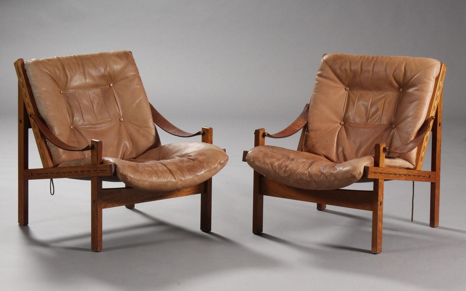 Thorbjørn Afdal, Norwegian designer. Pair of easy armchairs with solid walnut wood frame, loose cushions upholstered brown leather, safari-style, cognac-colored leather armrests.