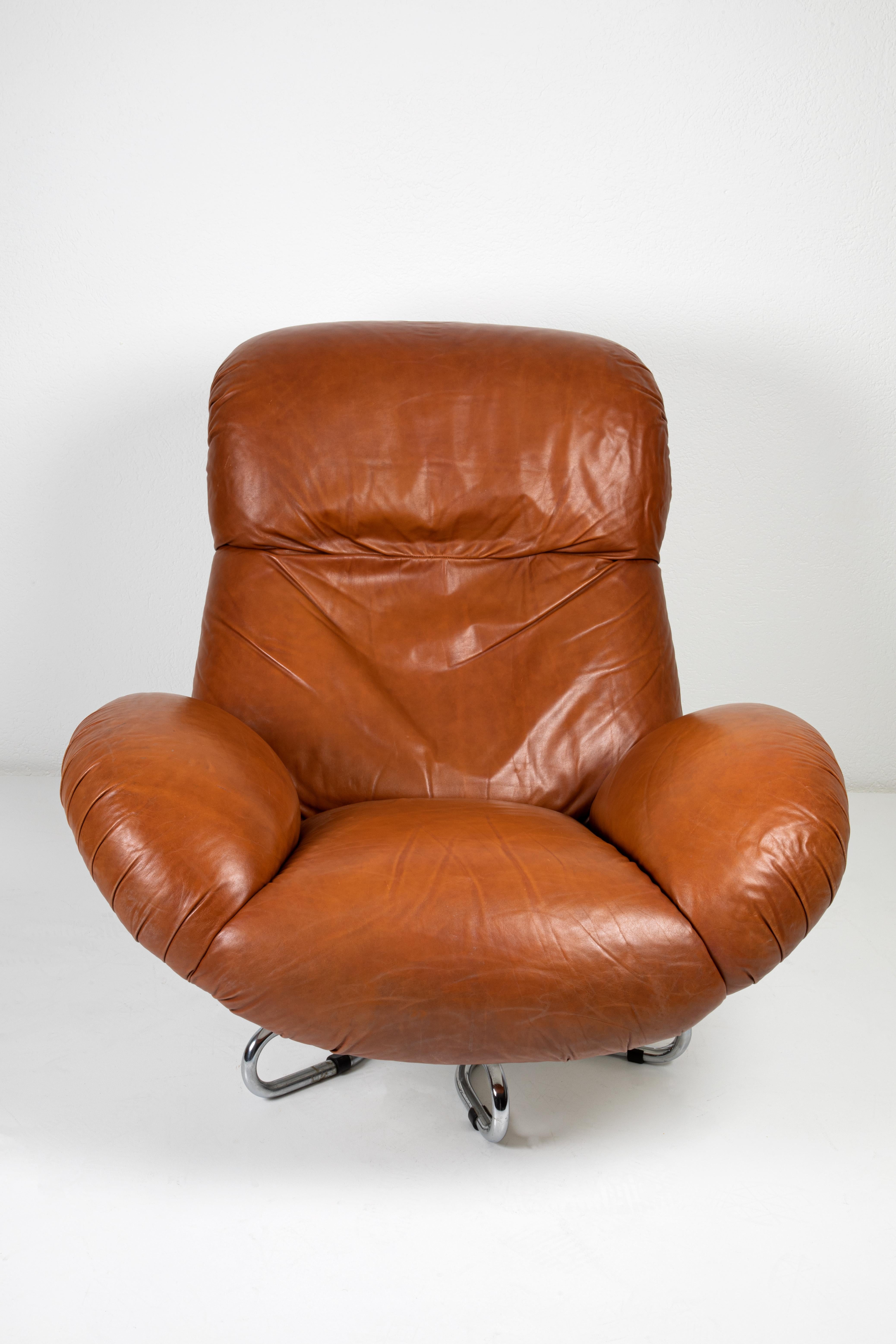 This Pair of Leather Armchairs, designed by Bruno Gecchelin and produced by Busnelli, Italy, in 1961, is an iconic example of mid-century modern Italian design. The armchairs feature Bruge leather upholstery with a thermoplastic polymer body and