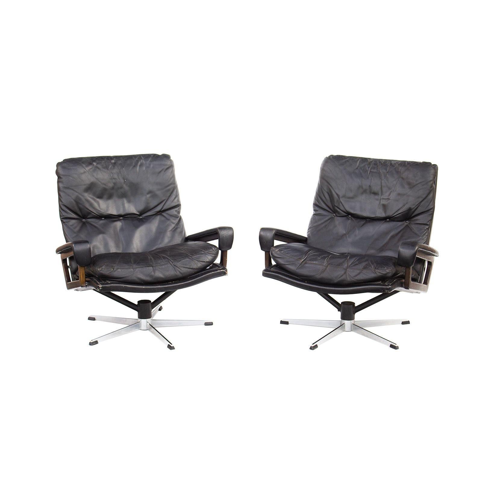Switzerland, 1960s
Pair of leather 'King Chair' swivel armchairs by Andre Vandenbeuck for Strässle Switzerland. They are upholstered in black leather and have sculpted arms in either rosewood or walnut. The bases are a five point design and swivel.