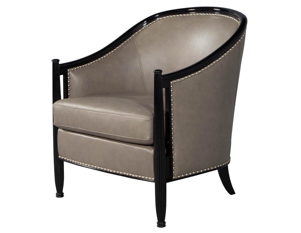Pair of leather Art Deco parlor armchairs with black lacquer finish. These Carrocel custom made Art Deco style chairs, sleek design with period styling and proportions, finished in a hand rubbed high gloss black lacquer accented with nickel head to