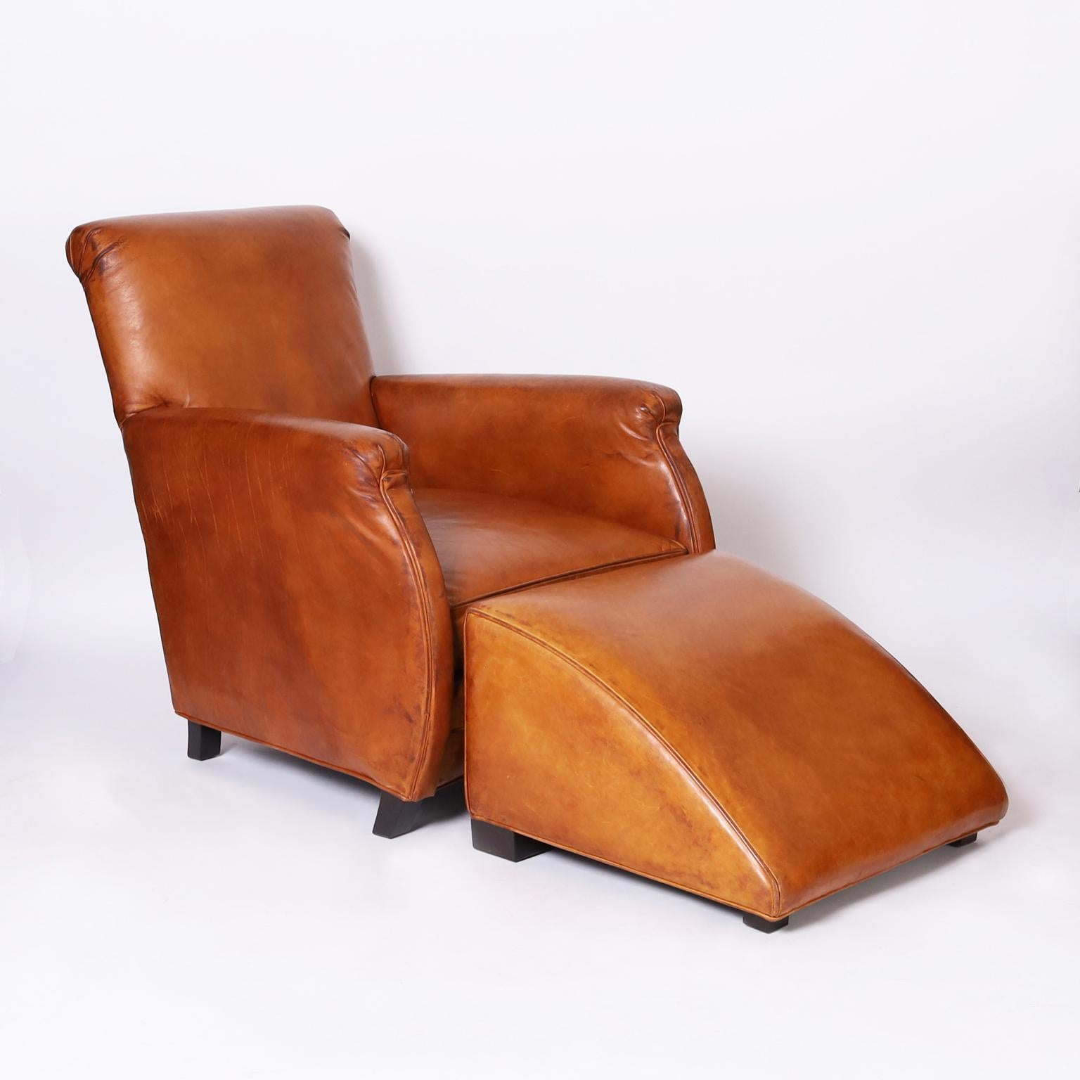 Impressive pair of art deco style armchairs having a classic steamline form upholstered in alluring soft brown leather and sporting matching ottomans. Signed William Allen for Grange.

Chairs: H: 36 W: 29 D: 34 SH: 16
Ottomans: H: 15 W: 22 D: 22