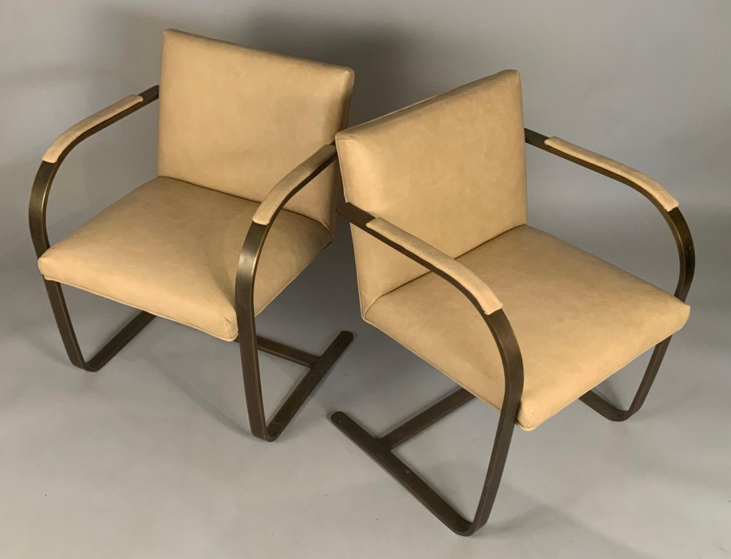 a pair of 1960's Flat Bar Brno chairs designed by Mies Van der Rohe for Knoll, in the rare Bronze finish. these classic and iconic Brno chairs are cantilevered, and have just been reupholstered in a caramel colored leather. beautiful chairs and the