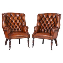 Pair of Leather Button Tufted Wingback British Colonial Style Armchairs