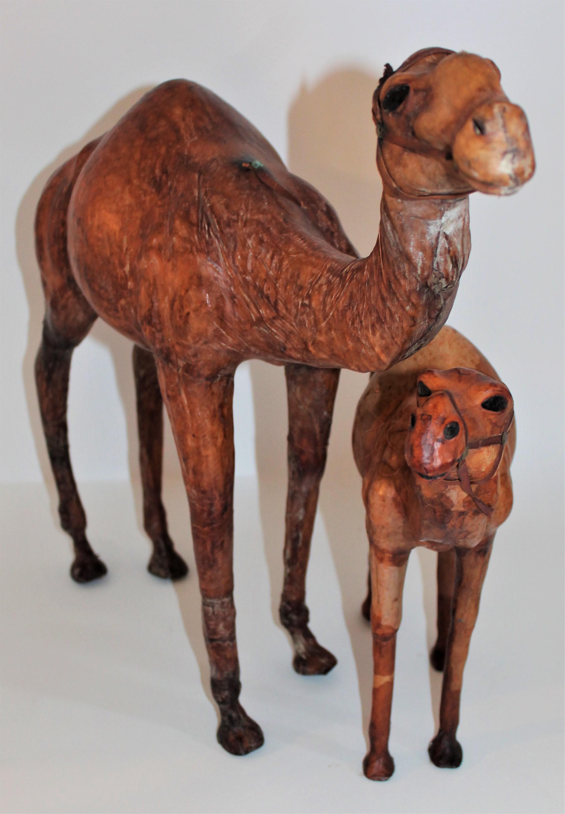 This fun pair of leather full body camels are in good condition. There is a tall large camel and med. size. Both in good condition.