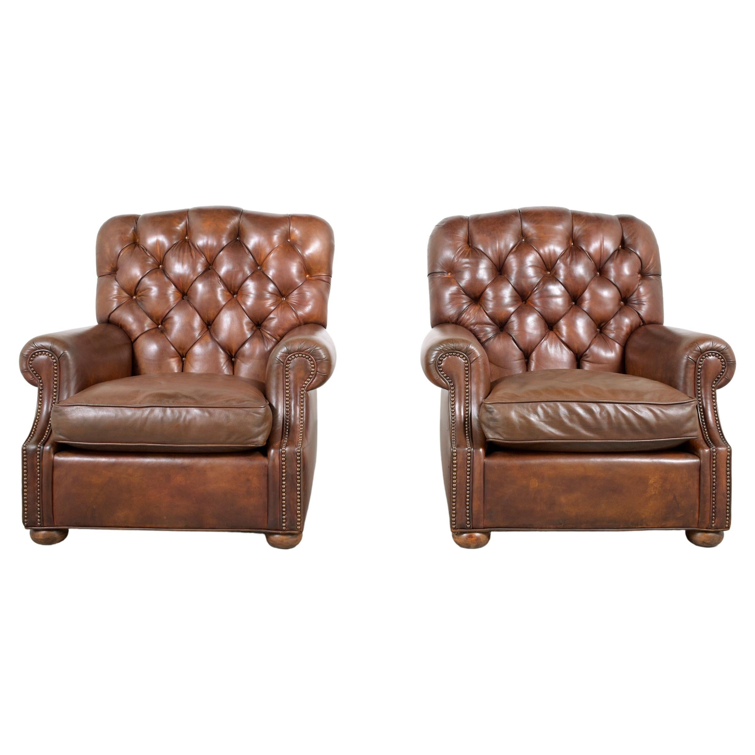 An extraordinary Pair of Leather Chesterfield Chairs in great condition executed out of leather and feature leather upholstery with a tufted design, brass nailhead trim details comfortable removable seat cushions. These chairs are dyed in brown