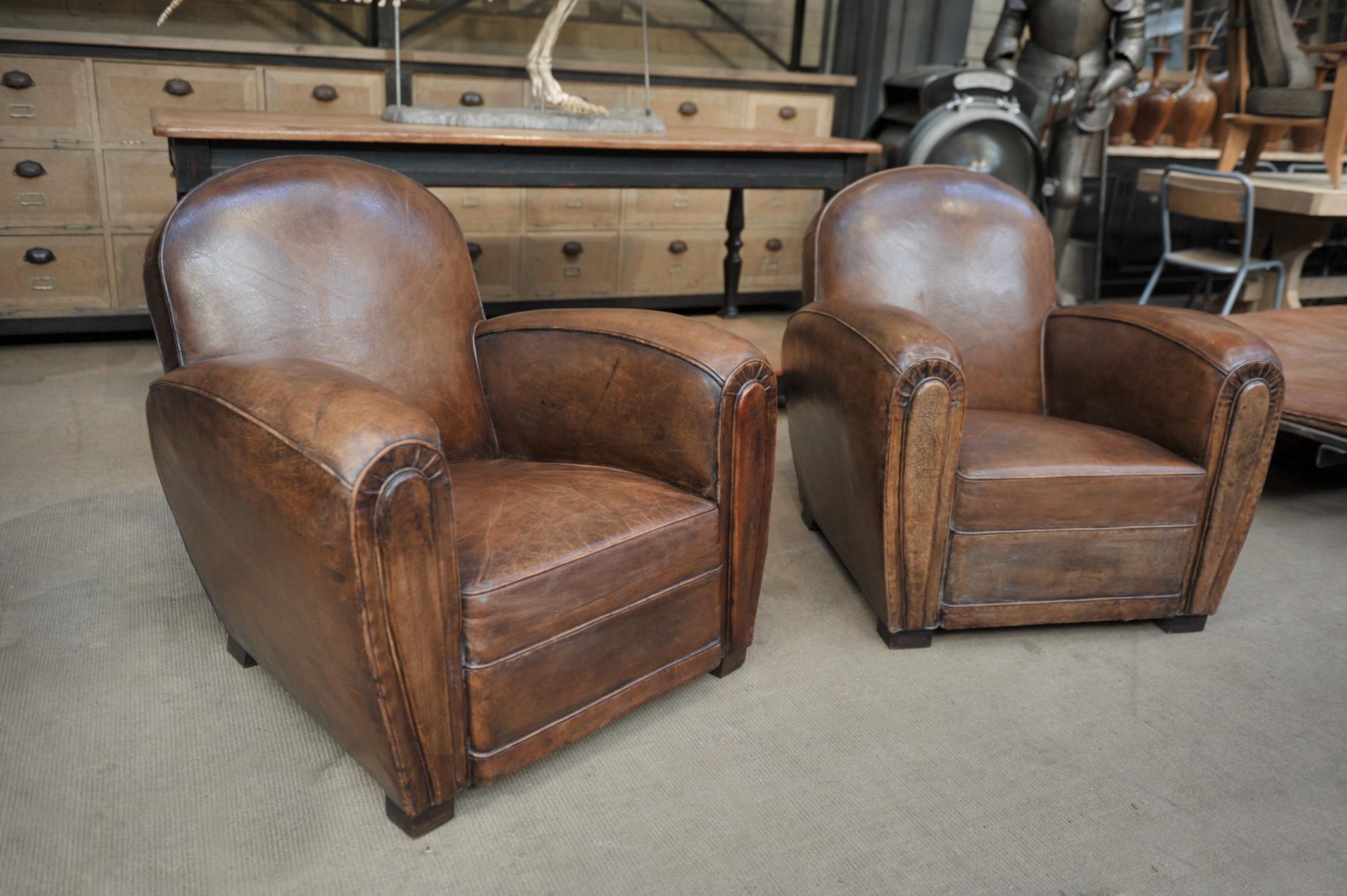Pair of French leather club chairs with original brown leather 1950 Very good condition, very little scratches and one hall in the back see last picture. Very comfortable.
