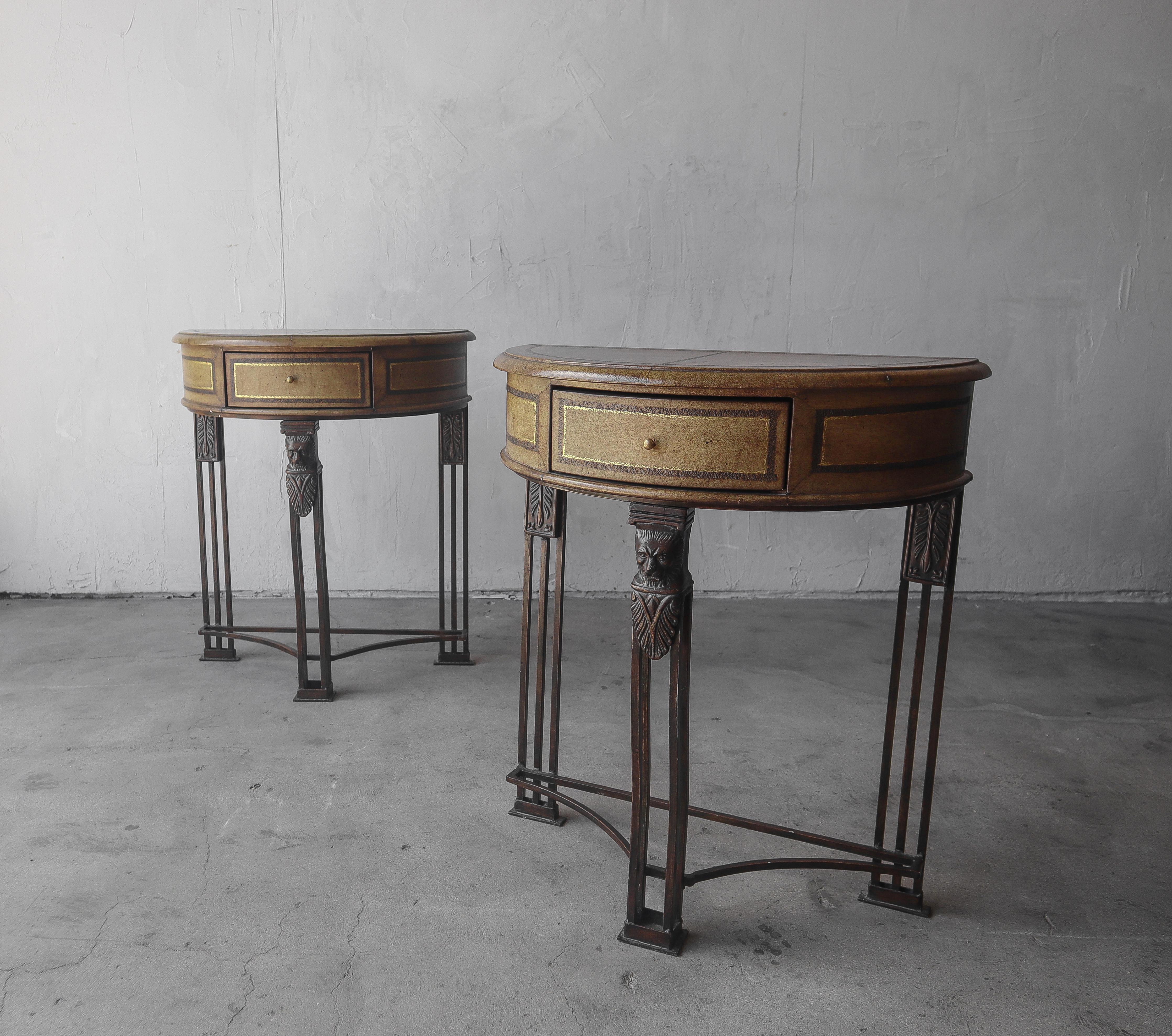 Petite pair of leather and metal demilune tables by Maitland Smith.  Each table features a single small drawer.

Tables are in overall good condition, showing some minimal signs of wear from age and use but no actual damage.