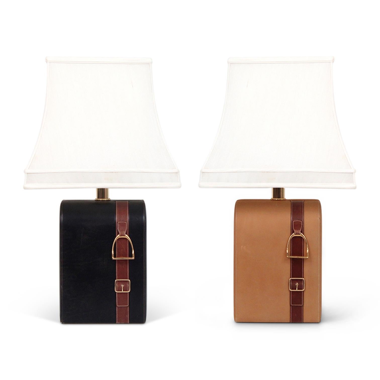 Pair of equestrian themed table lamps by Gucci. One in black and one in a natural saddle colored leather. Brass stirrups and stitched belting leather details. Made in Italy circa the 1970's.

 