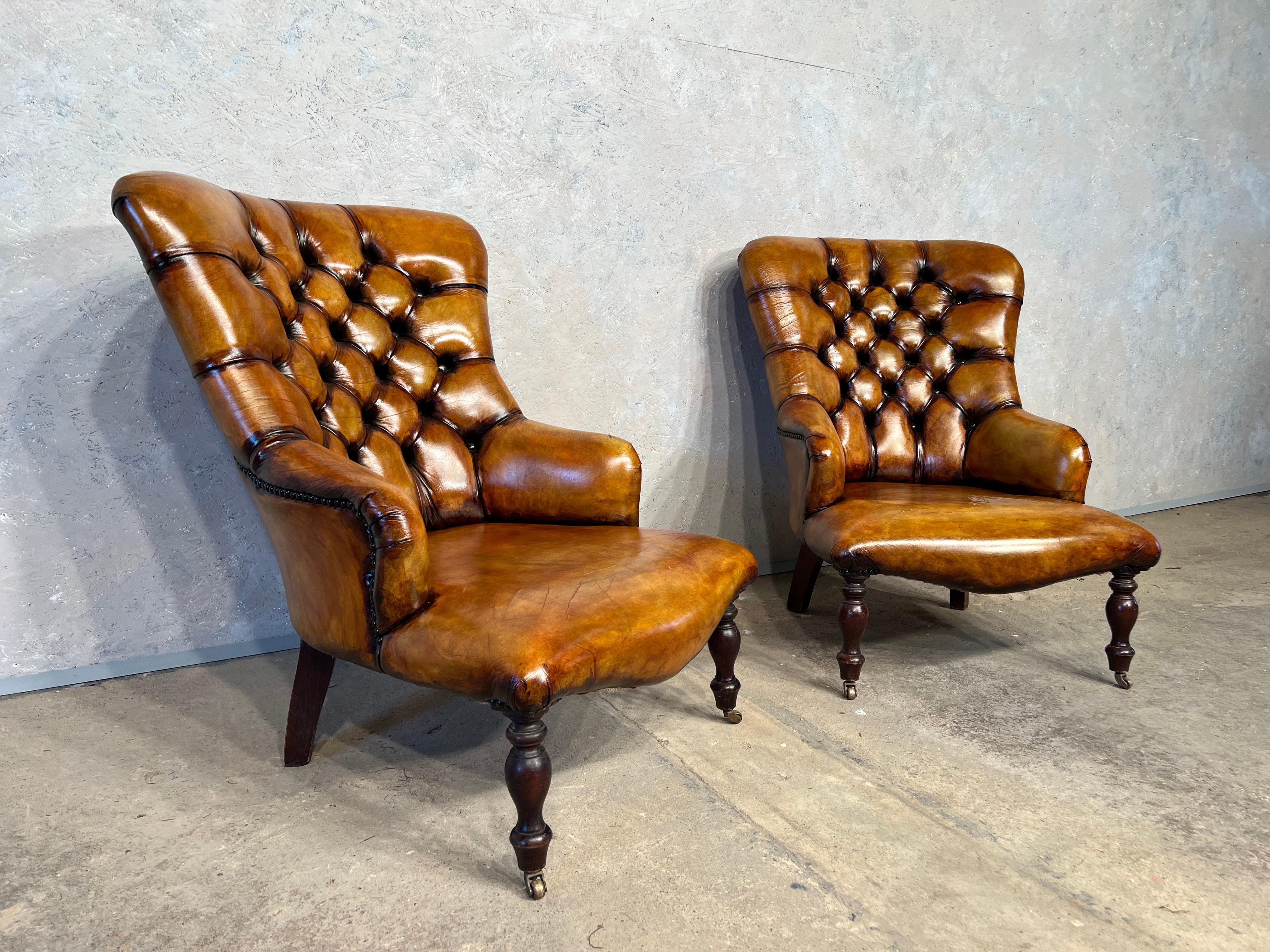 A Fantastic pair of mid-century leather fireside chairs in the 19th C Manner, in an amazing hand dyed patinated light tan with a lovely finish, resting on solid mahogany turned legs on brass castors.


In great condition.


 