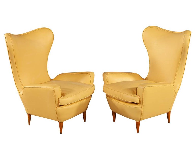 Pair of Leather Italian lounge chairs attributed to Paolo Buffa. Featuring unique curved design in a burnished yellow leather. Leather does have some fading on seat corner and back.

Price includes complimentary curb side delivery to the