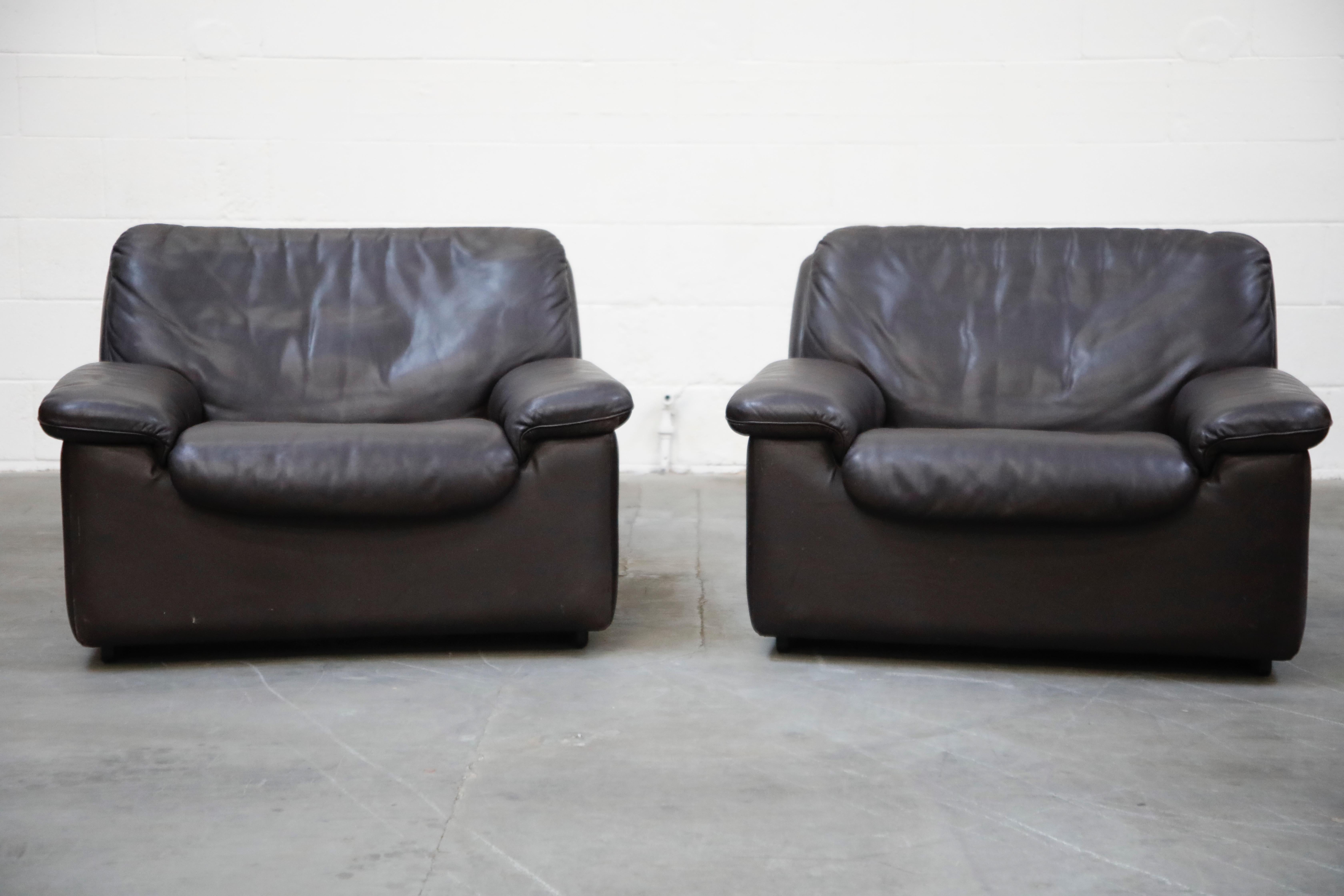 A pair of incredibly laid-back and comfortable De Sede leather club chairs in an attractive high quality deep colored leather, designed and produced in the 1960s in Switzerland. The design features clever lines and shapes, making this work well in a