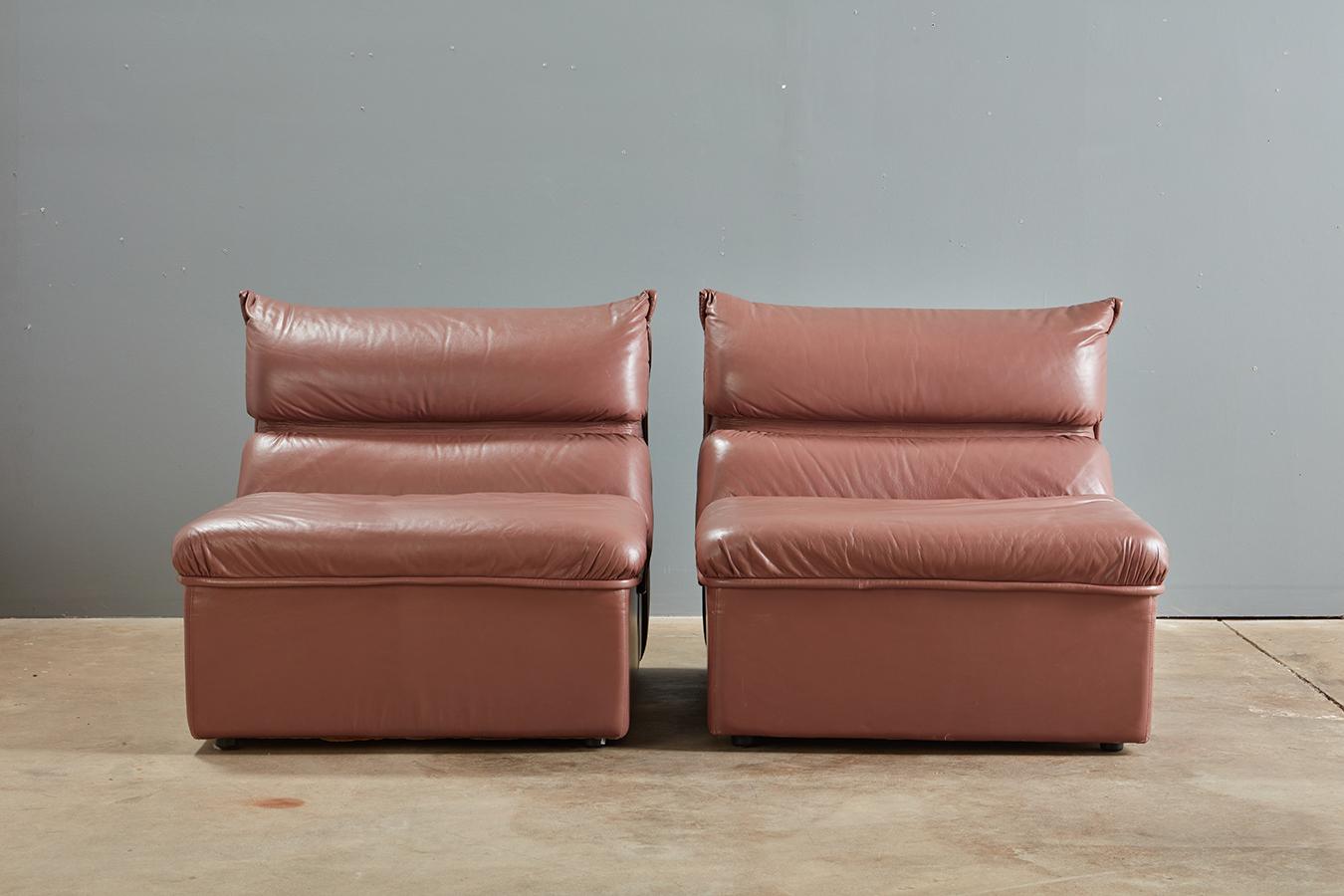 A pair of leather postmodern lounge chairs by Guido Faleschini, I4 Mariani For Pace Collection.

Original buttery soft leather in an uncommon sophisticated neutral; I would call this color a brown in the realm of a chocolate milk tone with a