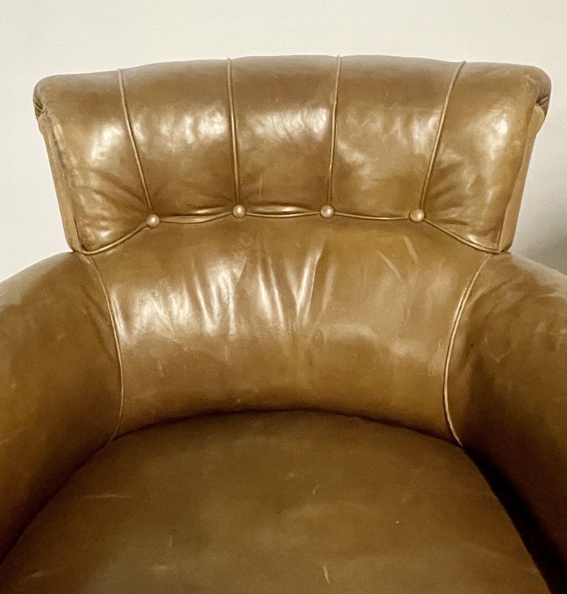 A pair of Georgian Tuffted leather club, lounge or cigar room Bergeres. Each in a fine worn brown leather on sprayed mahogany feet. The pair having a nice even aged worn look with button backs and oversized rolling arms. 
 
One chair with tear on