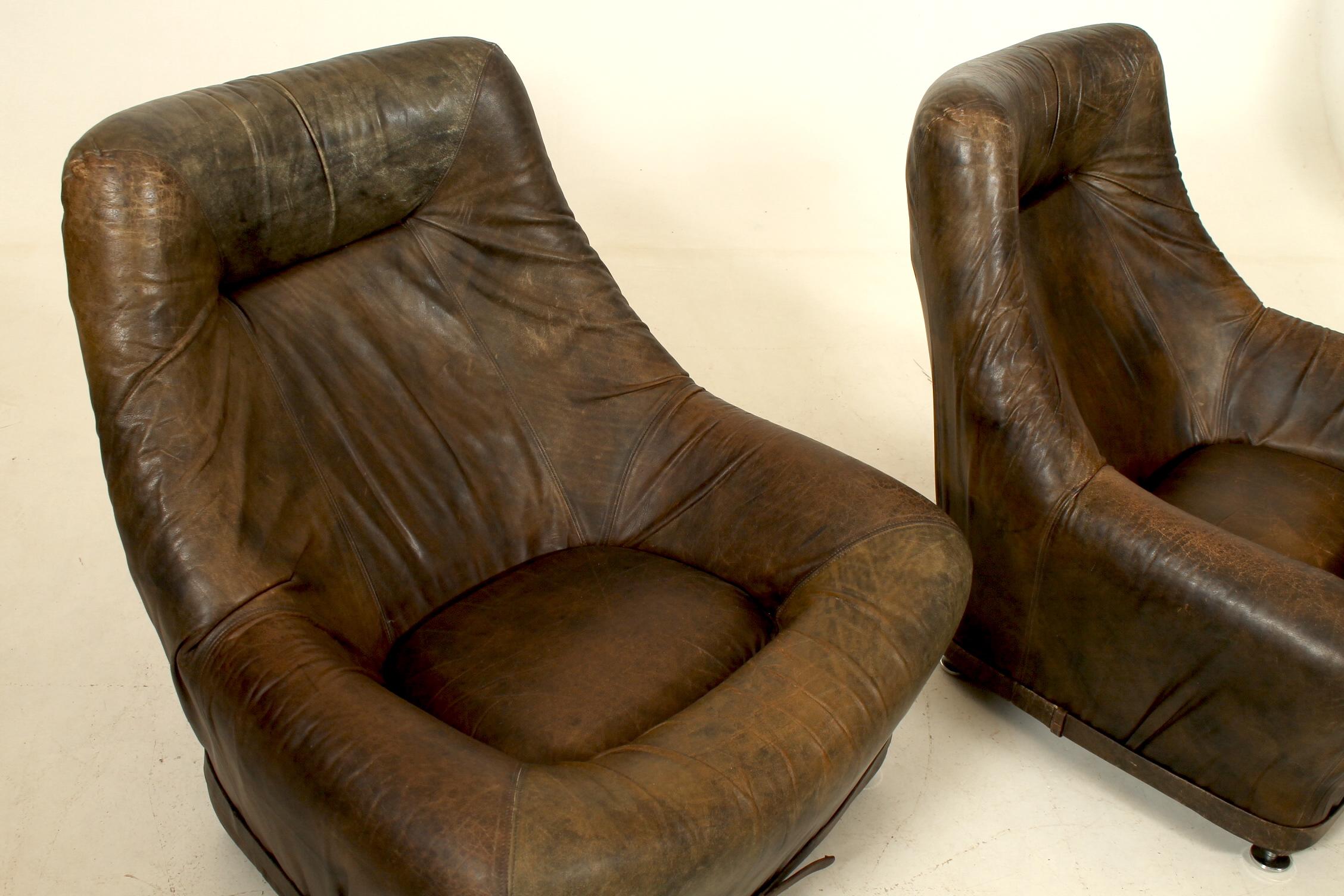 Mid-Century Modern Pair of leather loungers with a belt. Attributed De Sede. For Sale